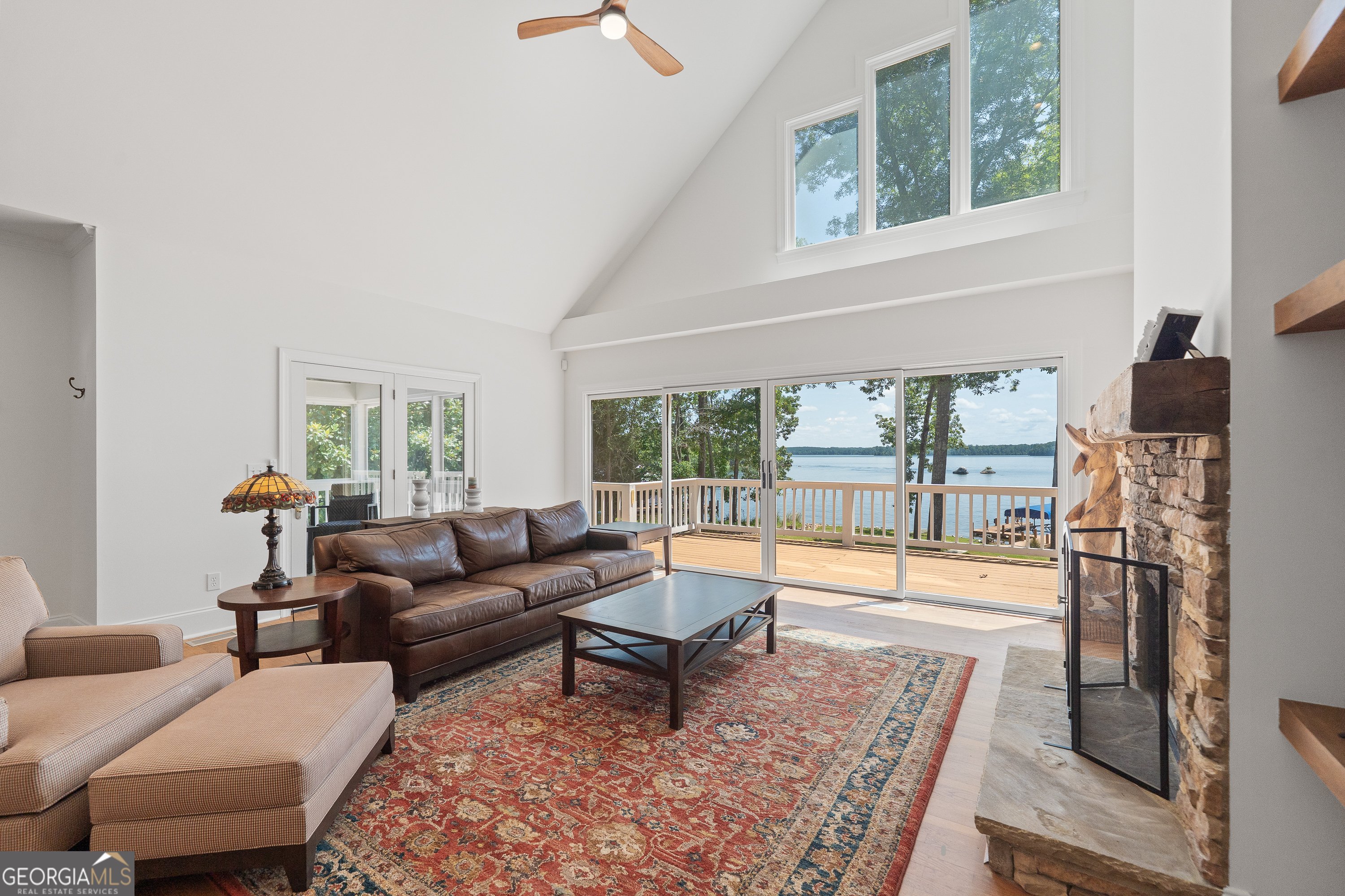 264 Winding River Road Eatonton, GA 31024 - Photo 11 of 72 a living room with furniture and a floor to ceiling window