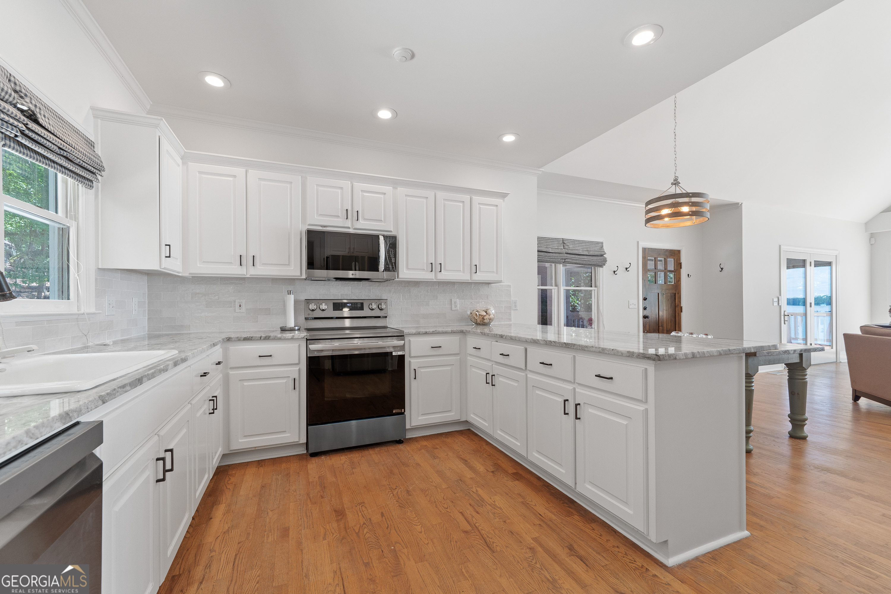264 Winding River Road Eatonton, GA 31024 - Photo 17 of 72 a kitchen with granite countertop a sink stainless steel appliances and cabinets