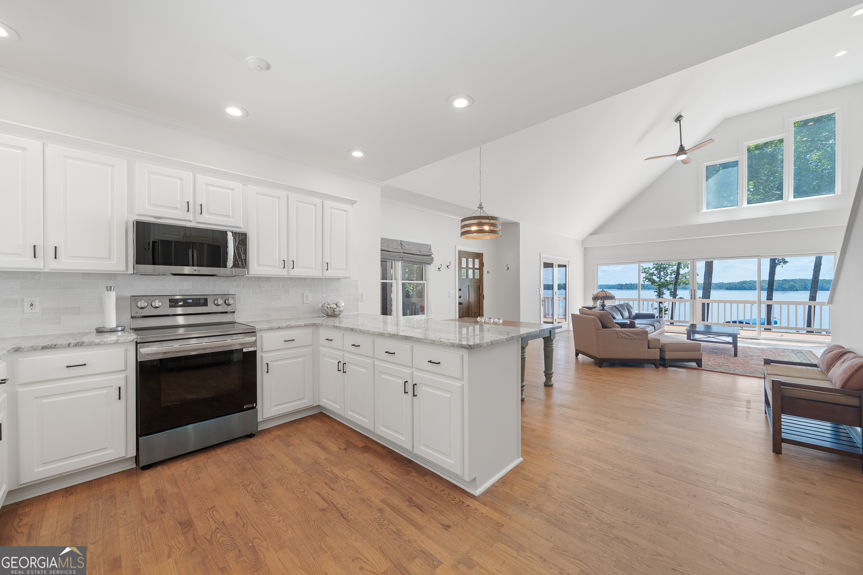 264 Winding River Road Eatonton, GA 31024 - Photo 21 of 72 a kitchen with granite countertop a stove a sink and a refrigerator