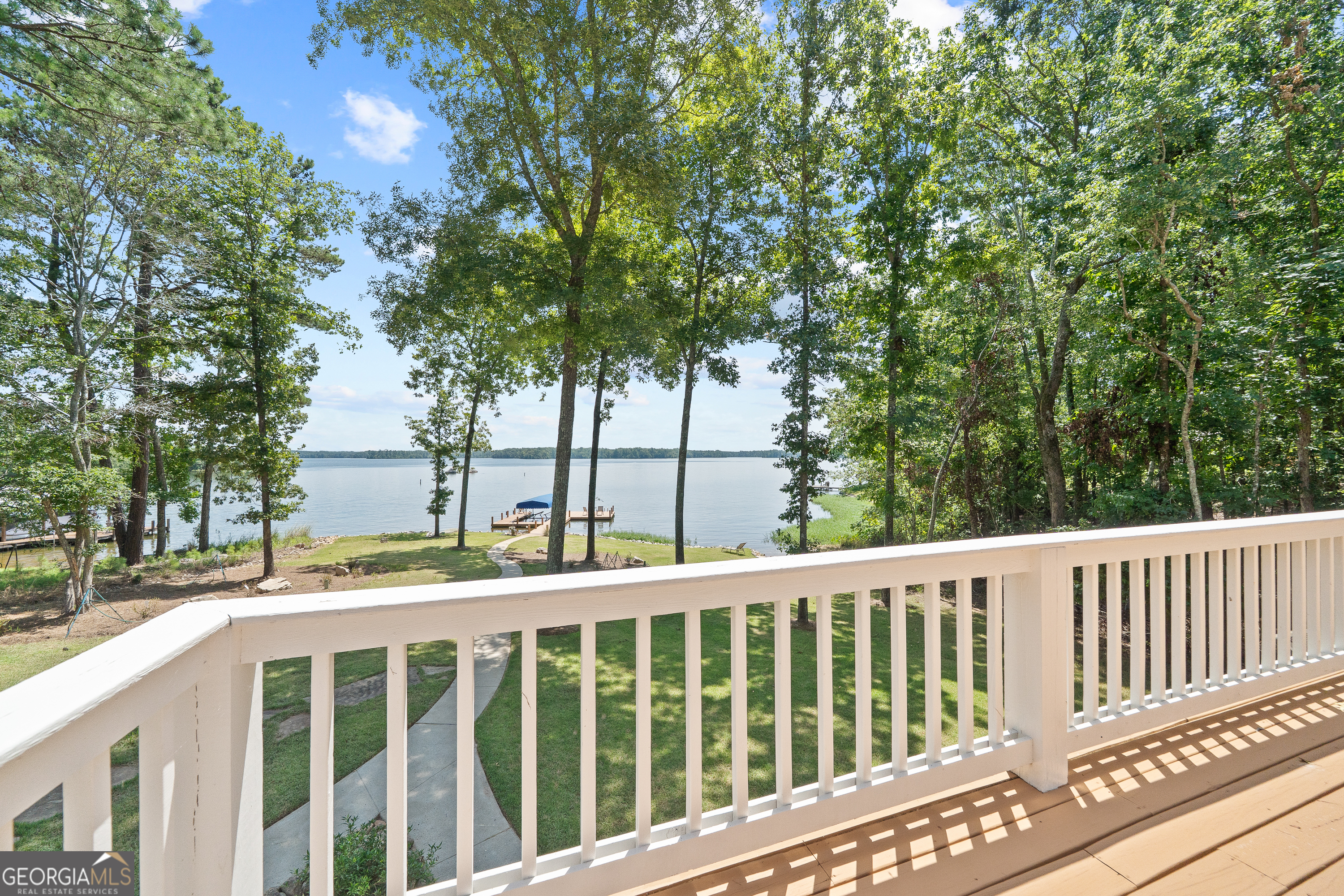 264 Winding River Road Eatonton, GA 31024 - Photo 23 of 72 a view of a balcony with wooden floor and fence