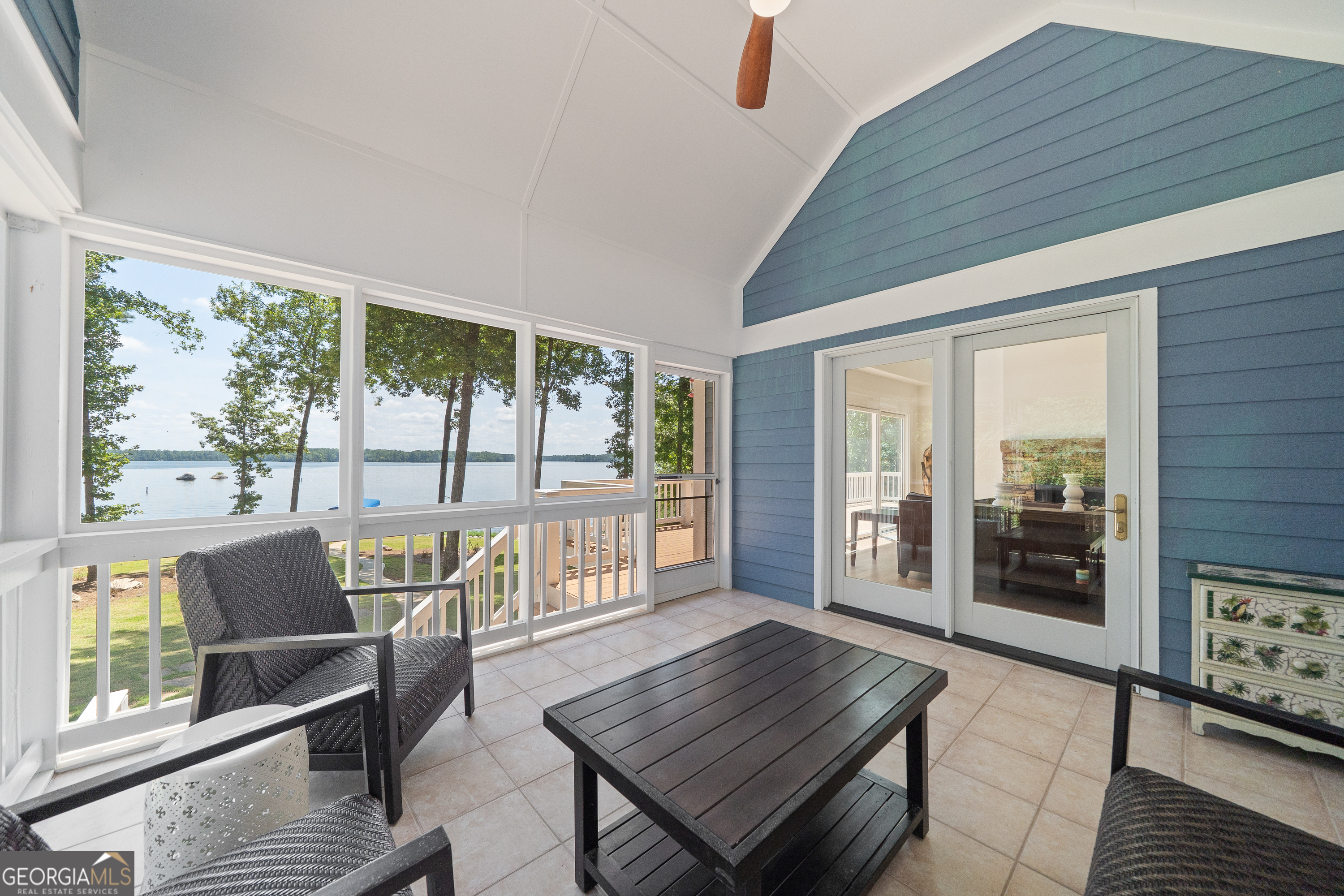 264 Winding River Road Eatonton, GA 31024 - Photo 26 of 72 a living room with furniture and a floor to ceiling window