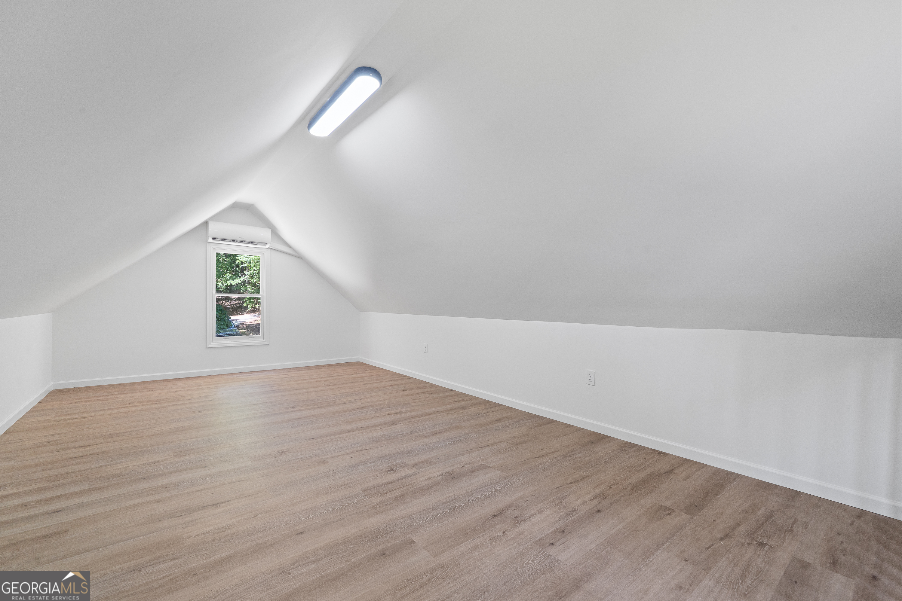 264 Winding River Road Eatonton, GA 31024 - Photo 27 of 72 an empty room with wooden floor and windows