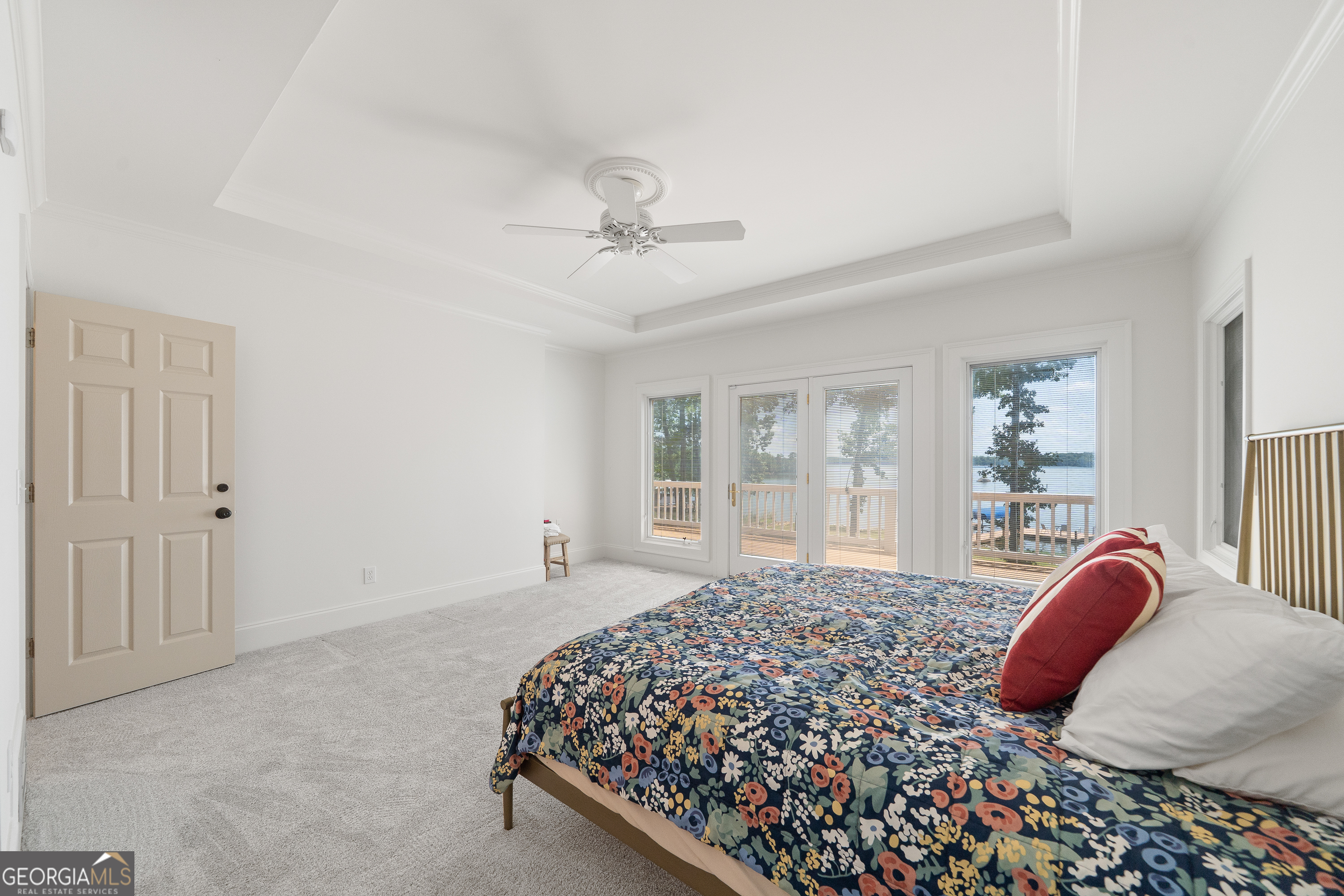 264 Winding River Road Eatonton, GA 31024 - Photo 30 of 72 a bedroom with a bed lamp and a large window