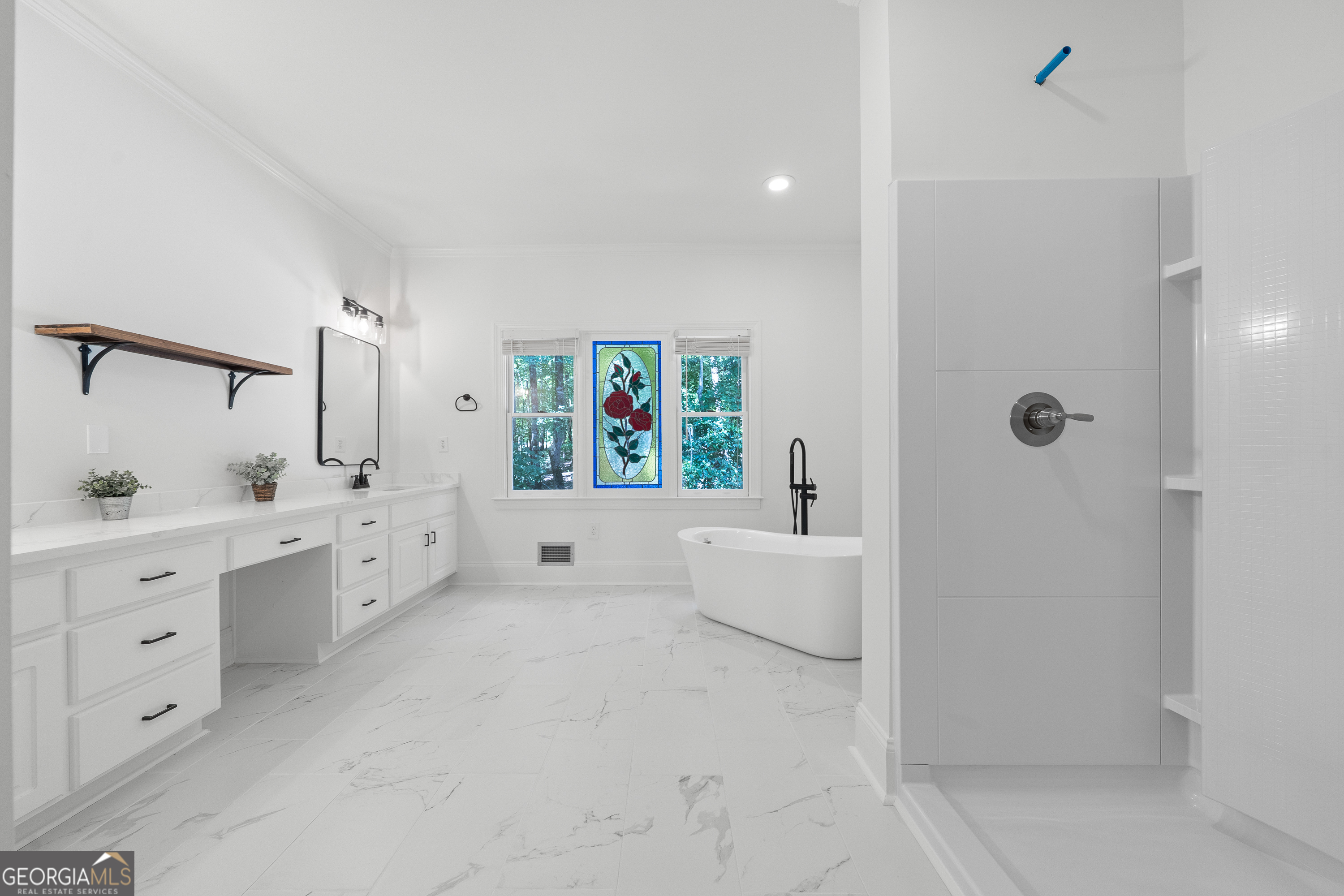 264 Winding River Road Eatonton, GA 31024 - Photo 34 of 72 a large white bathroom with a large tub sink vanity and mirror