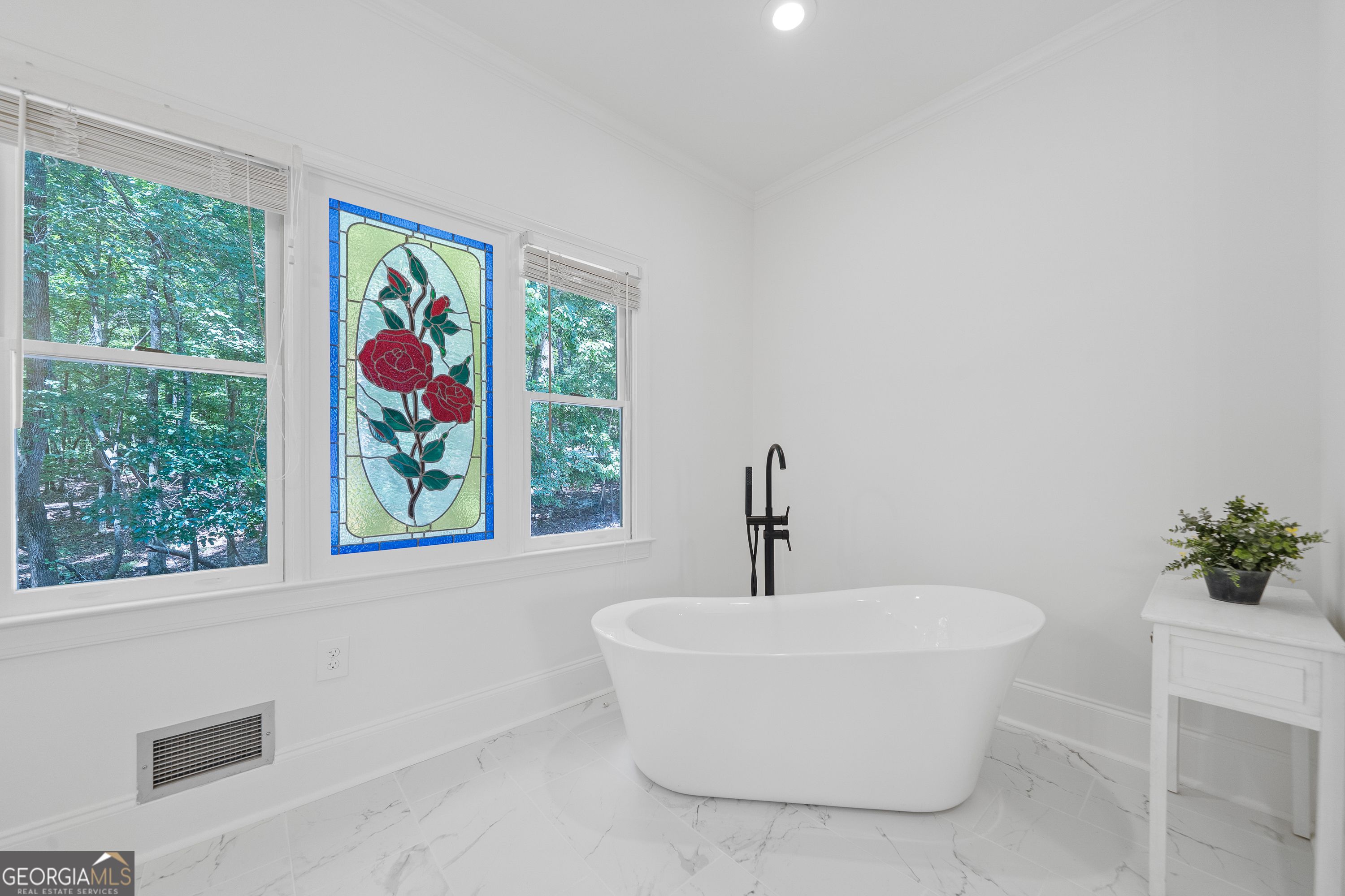 264 Winding River Road Eatonton, GA 31024 - Photo 37 of 72 a white bath tub sitting in a bathroom next to a window
