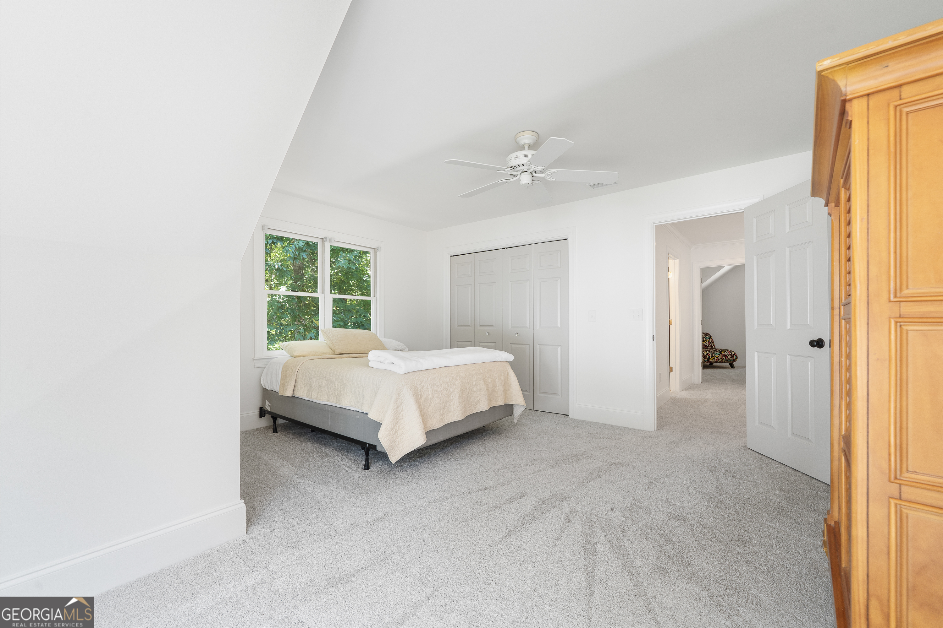 264 Winding River Road Eatonton, GA 31024 - Photo 45 of 72 a spacious bedroom with a bed and a window