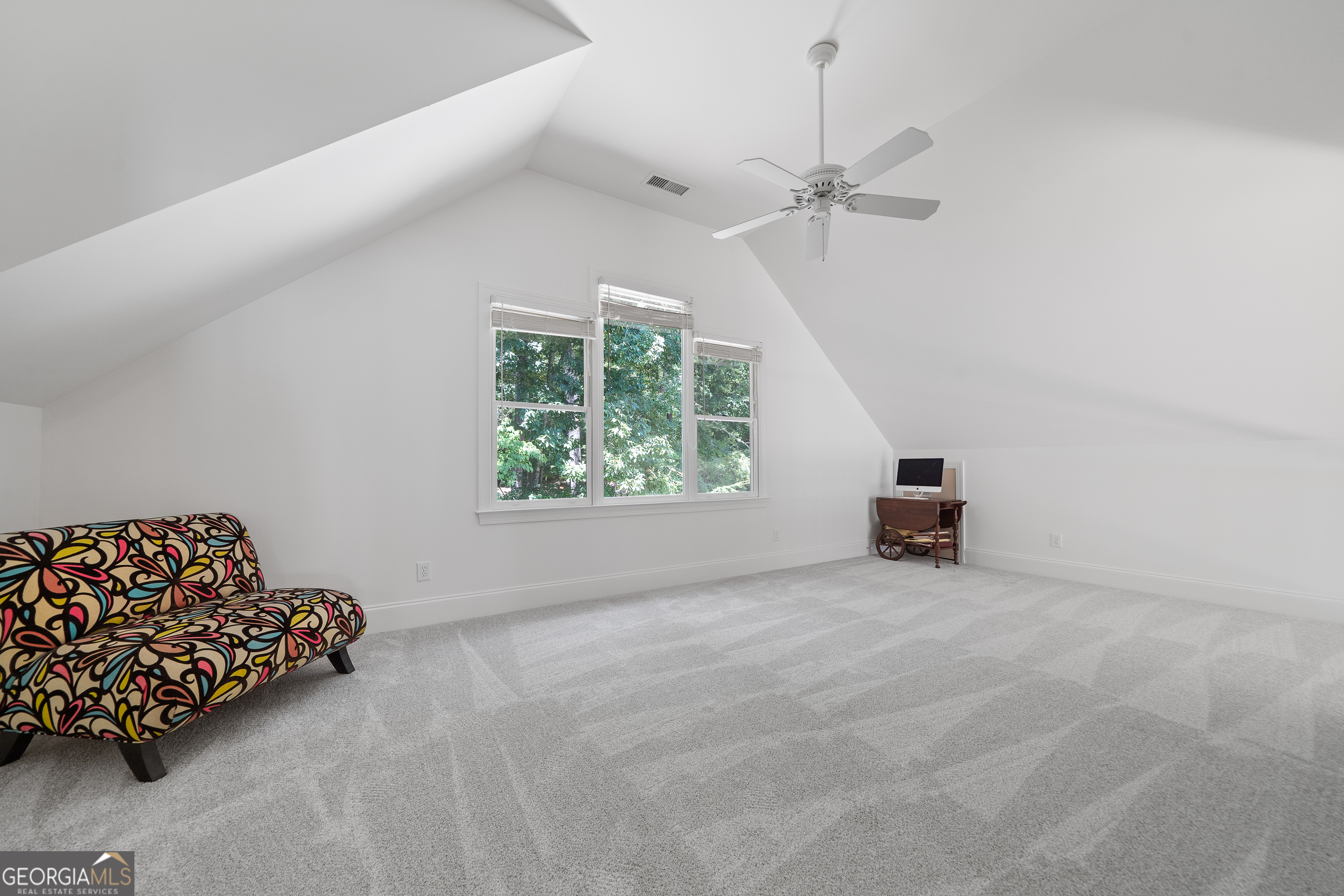 264 Winding River Road Eatonton, GA 31024 - Photo 46 of 72 an empty room with windows and a chandelier fan