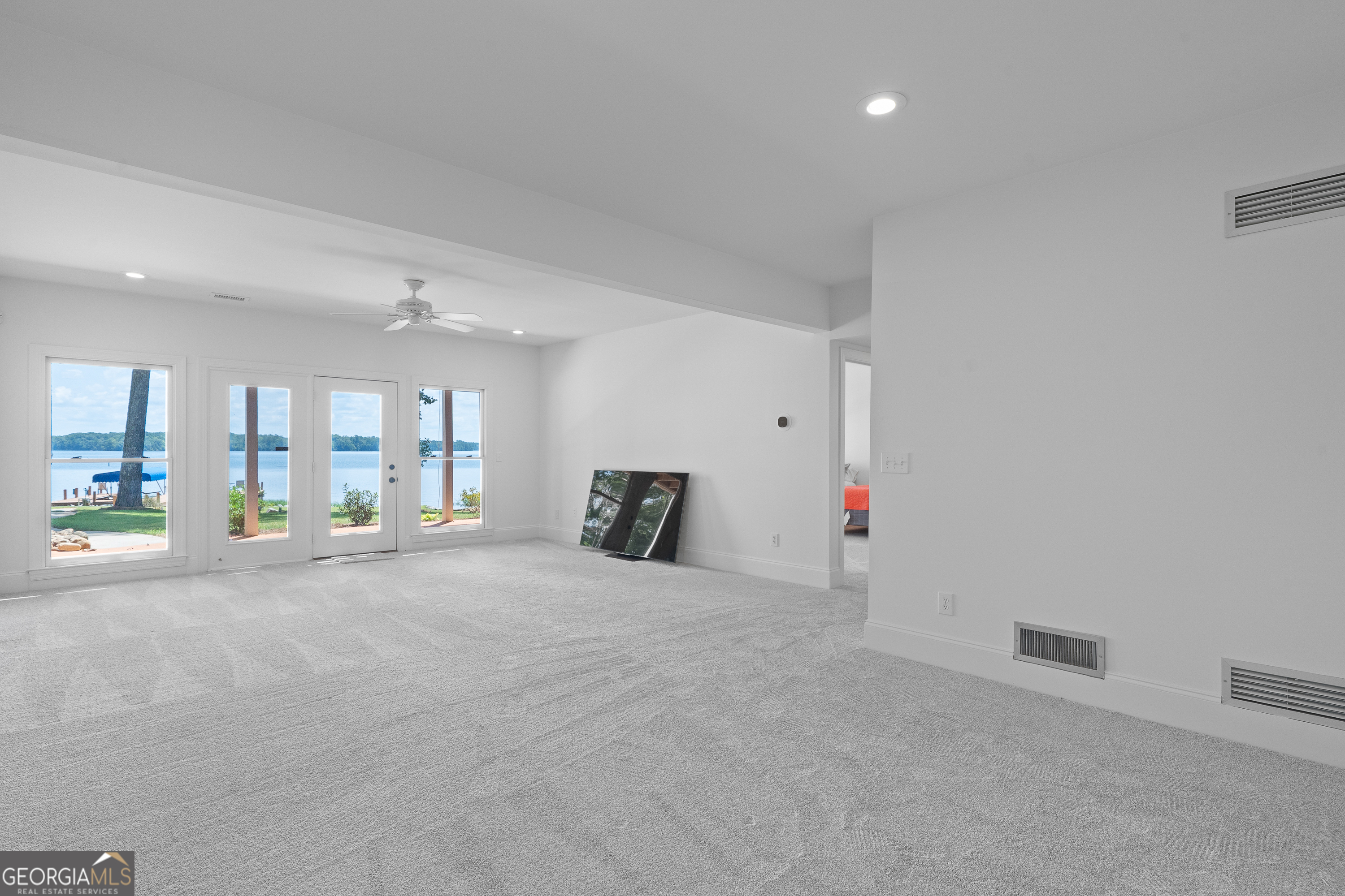 264 Winding River Road Eatonton, GA 31024 - Photo 51 of 72 a view of an empty room with wooden floor and a fireplace