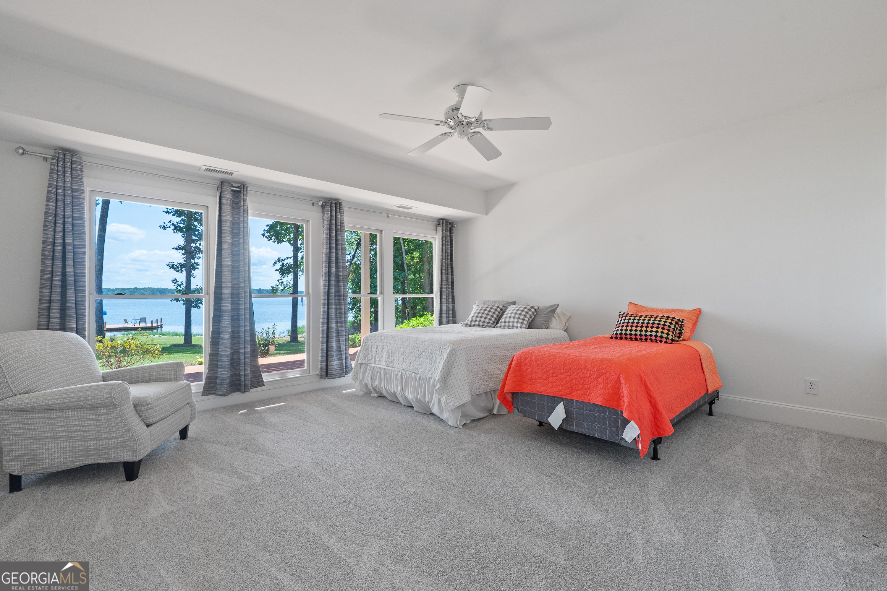 264 Winding River Road Eatonton, GA 31024 - Photo 53 of 72 a spacious bedroom with a bed and a couch