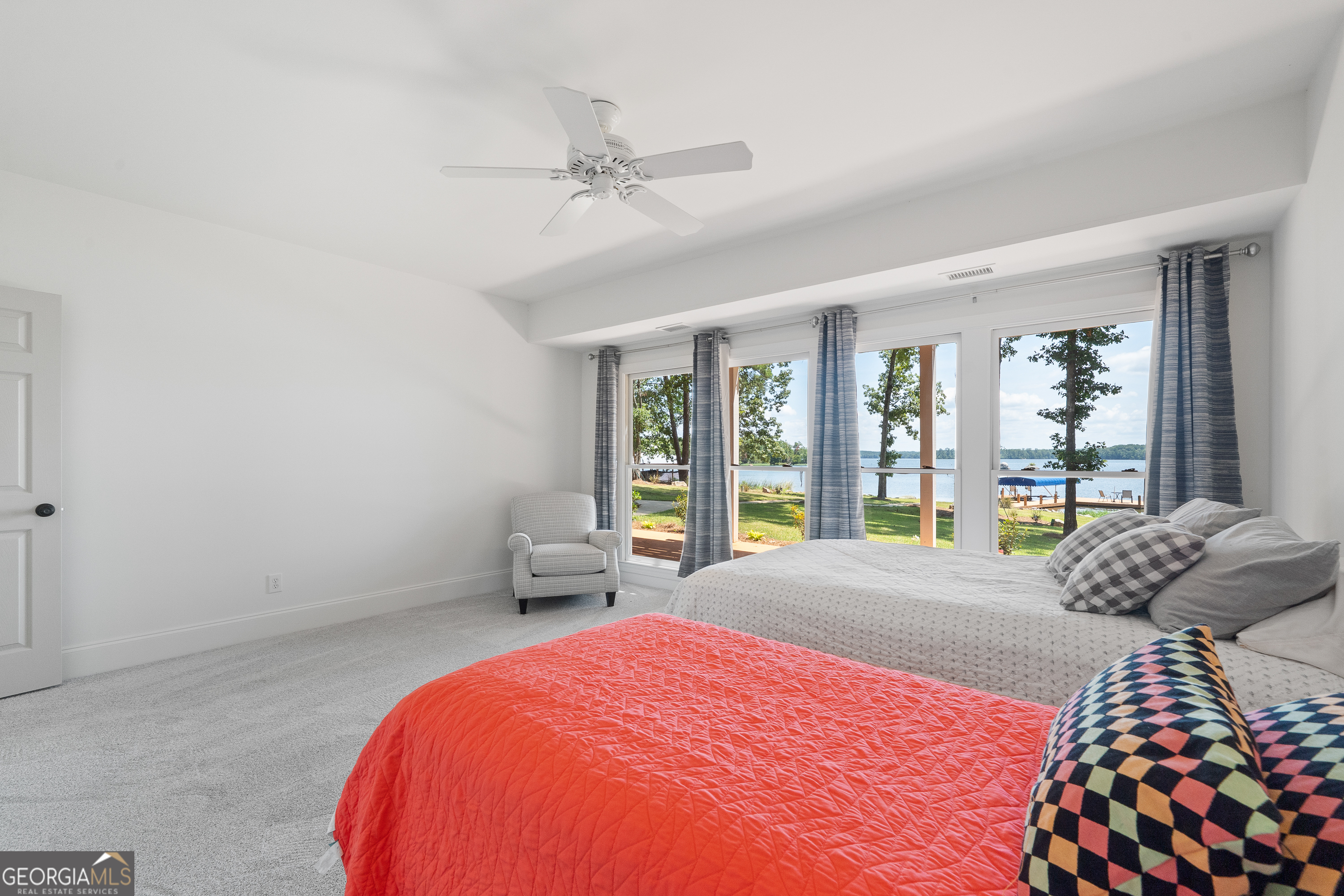 264 Winding River Road Eatonton, GA 31024 - Photo 54 of 72 a bedroom with a large bed and a large window