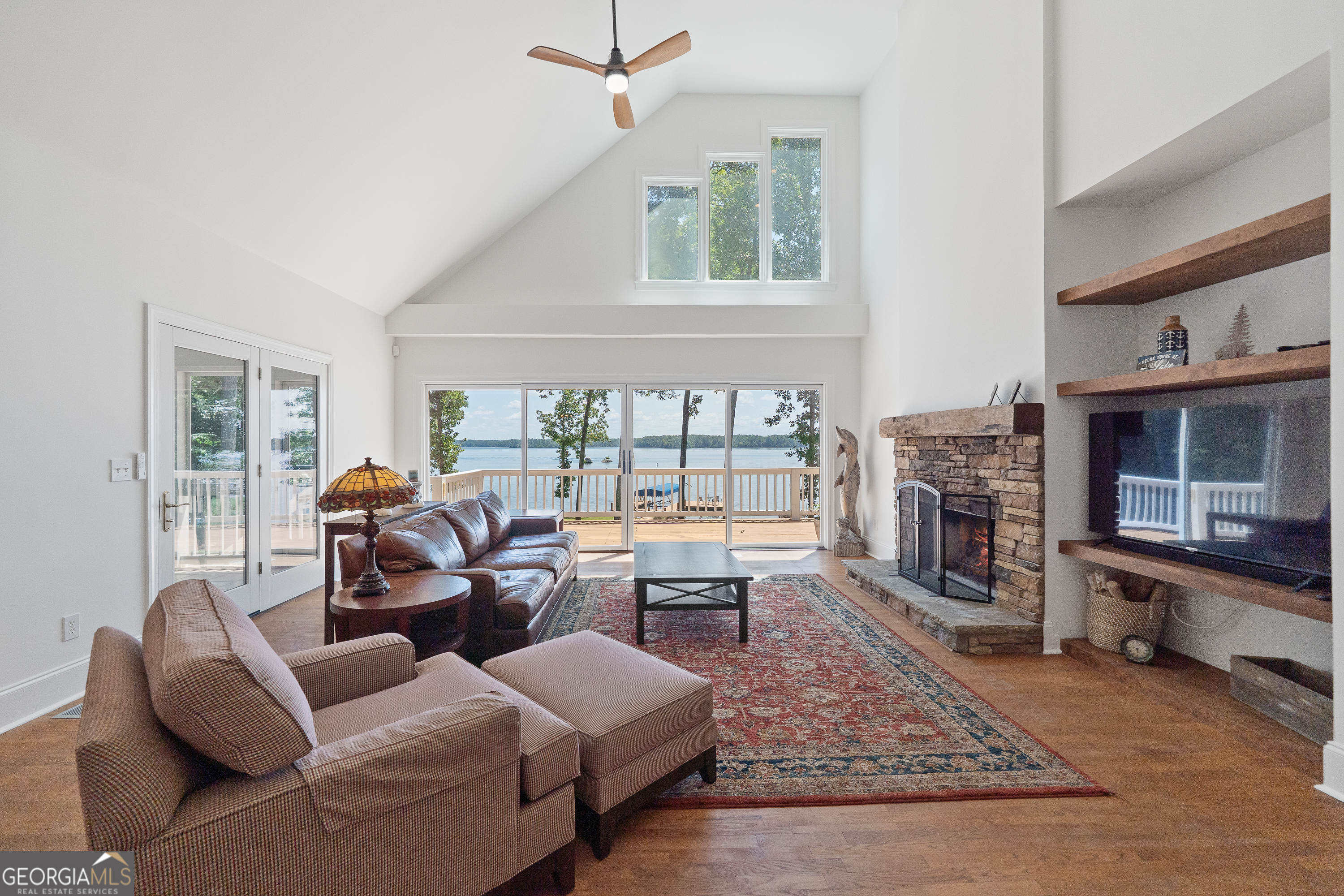 264 Winding River Road Eatonton, GA 31024 - Photo 10 of 72 a living room with furniture large window and a fireplace