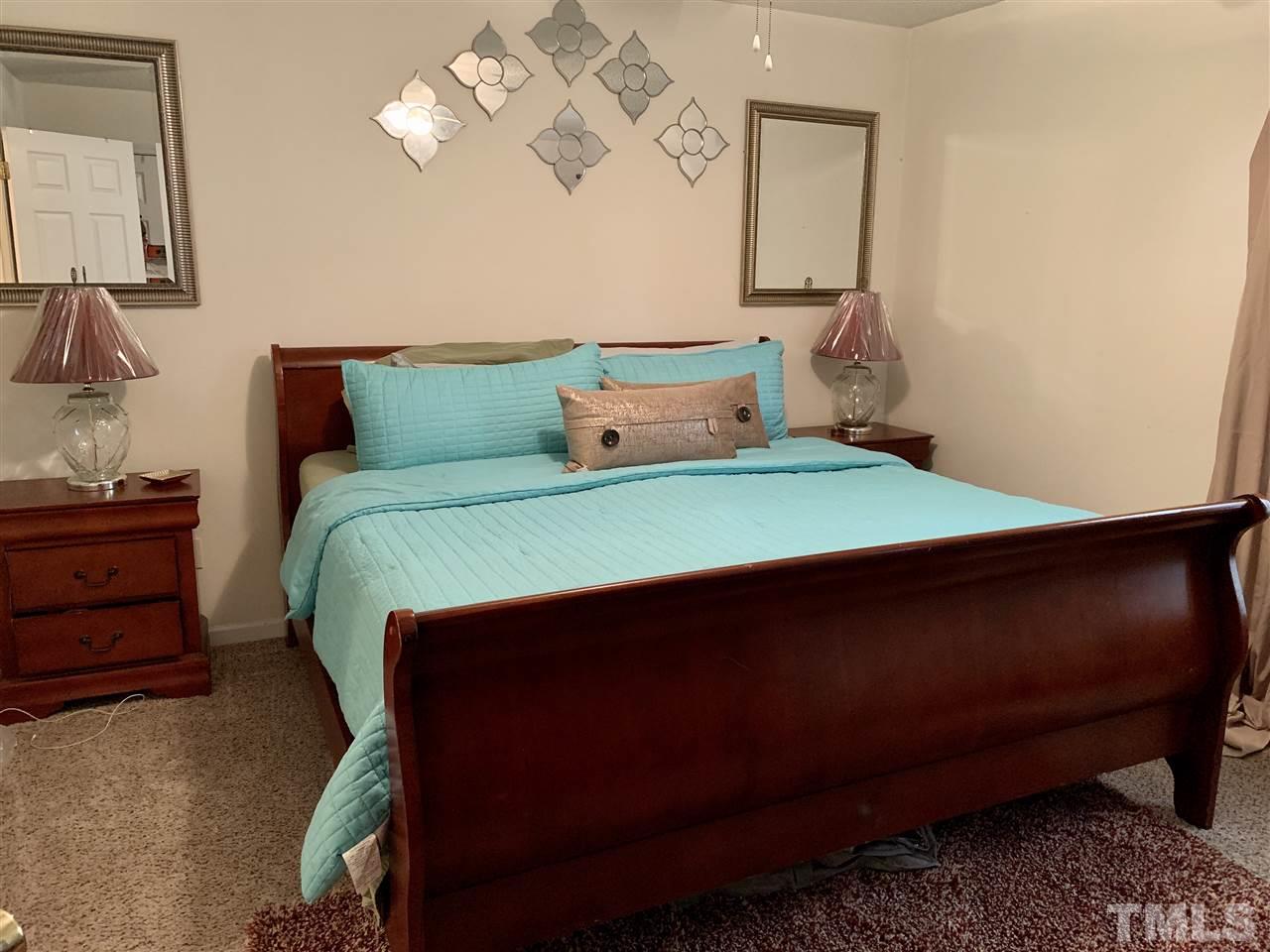 506 Huron Road Raleigh, NC 27610 - Photo 20 of 29 a bedroom with a bed and window