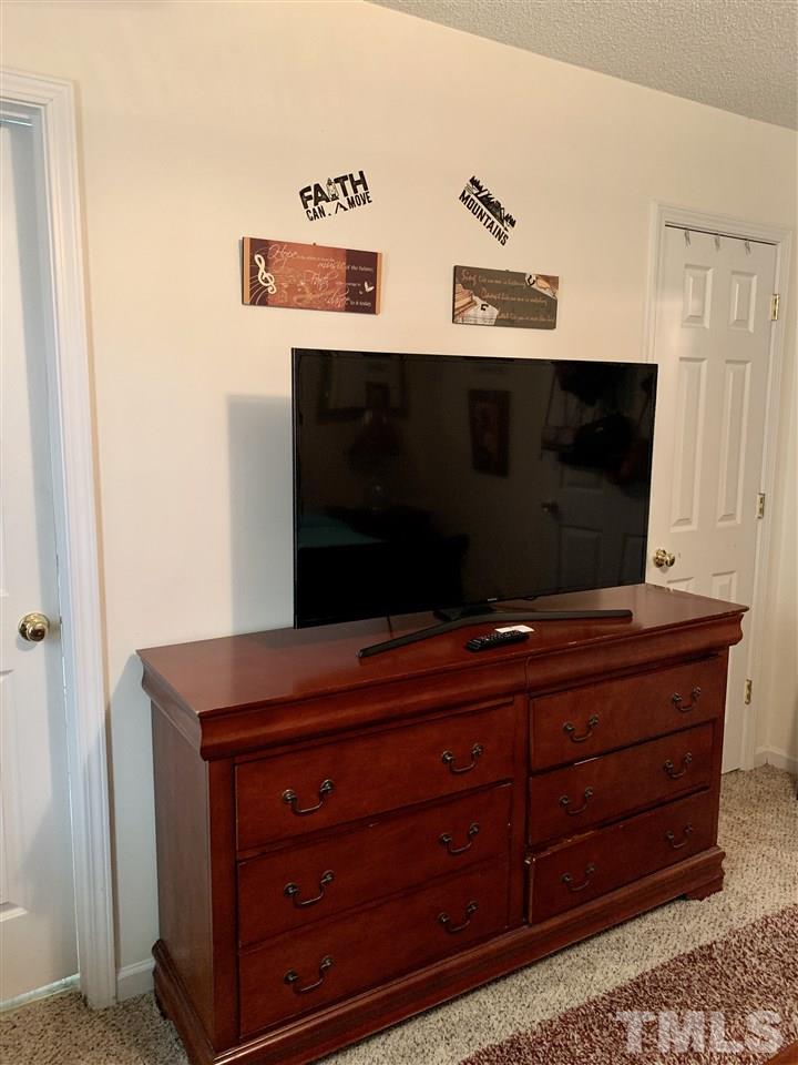 506 Huron Road Raleigh, NC 27610 - Photo 22 of 29 a living room with furniture and a flat screen tv