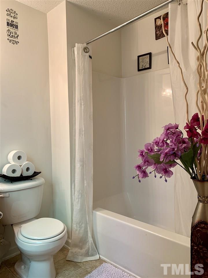 506 Huron Road Raleigh, NC 27610 - Photo 23 of 29 a bathroom with a toilet and a shower