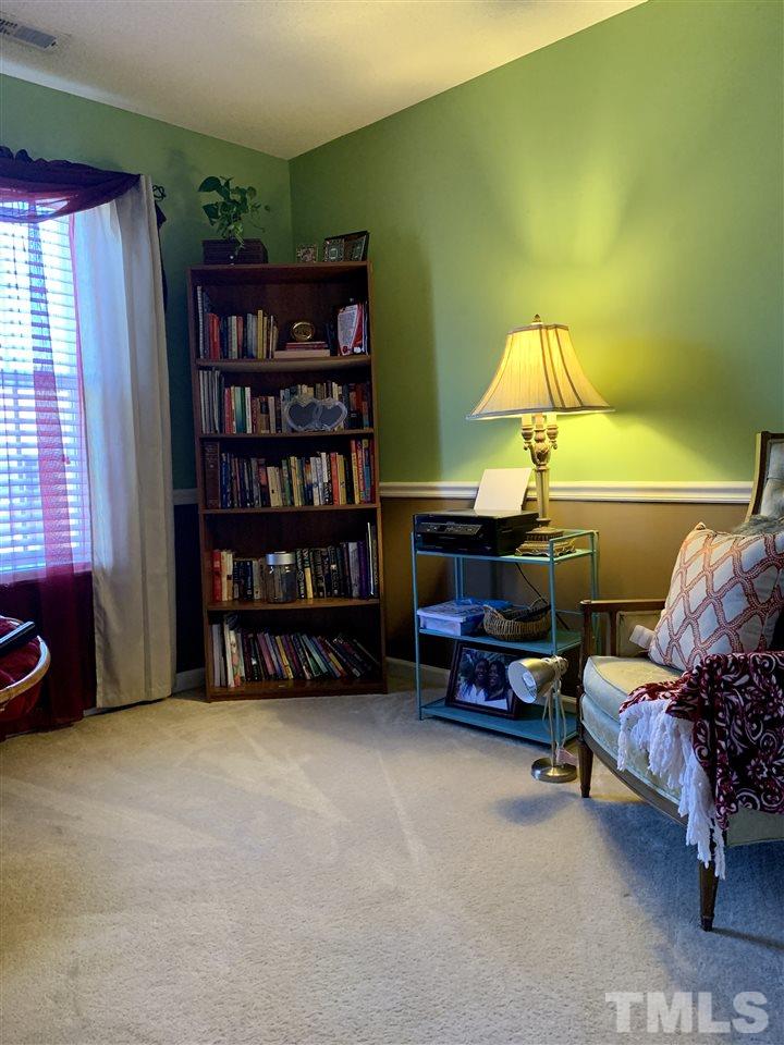 506 Huron Road Raleigh, NC 27610 - Photo 26 of 29 a living room with furniture and a lamp