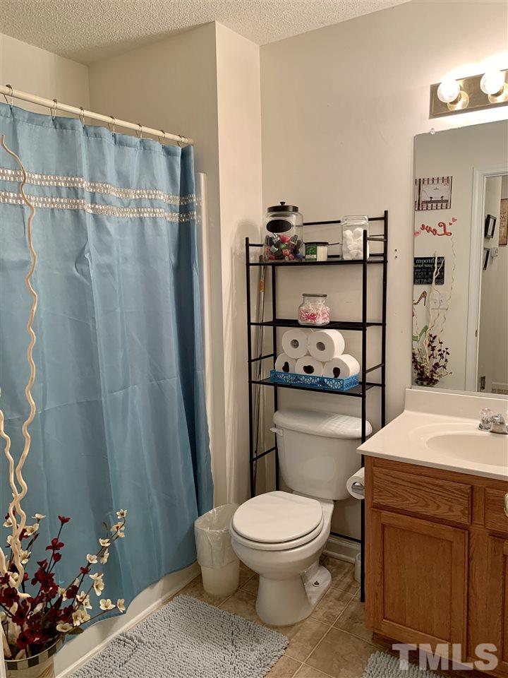 506 Huron Road Raleigh, NC 27610 - Photo 27 of 29 a bathroom with a toilet a sink and shower