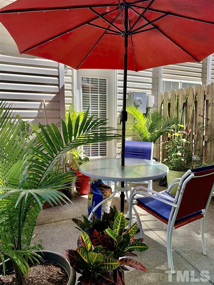 506 Huron Road Raleigh, NC 27610 - Photo 29 of 29 a view of a patio with table and chairs under an umbrella