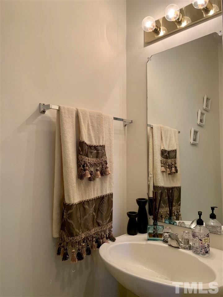 506 Huron Road Raleigh, NC 27610 - Photo 8 of 29 a bathroom with a sink and a mirror