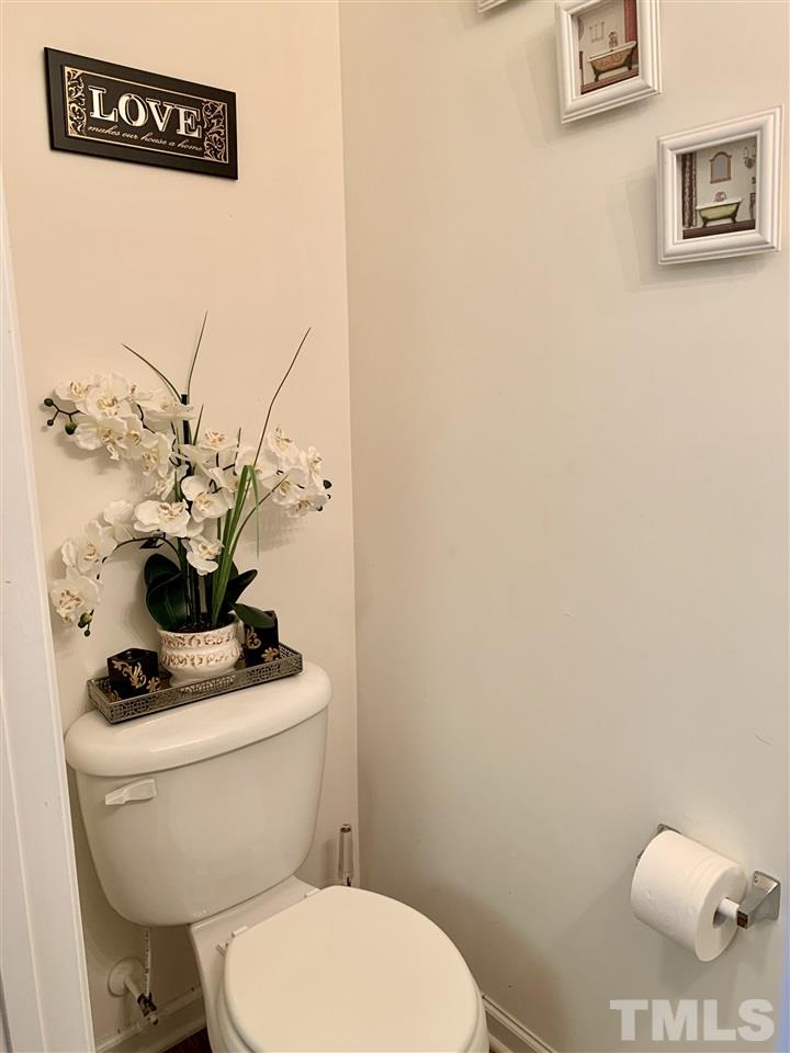 506 Huron Road Raleigh, NC 27610 - Photo 9 of 29 a bathroom with a toilet a sink and a mirror