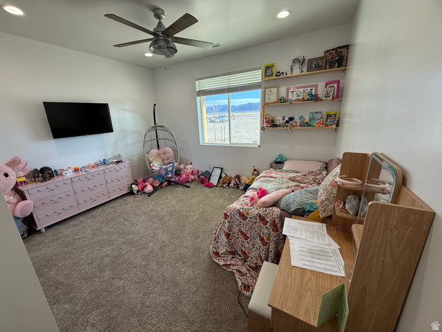 3550 North River Ln Road East Panguitch, UT 84759 - Photo 9 of 25 Carpeted interior room featuring a ceiling fan with integrated lighting, recessed ceiling lights, and a window with blinds