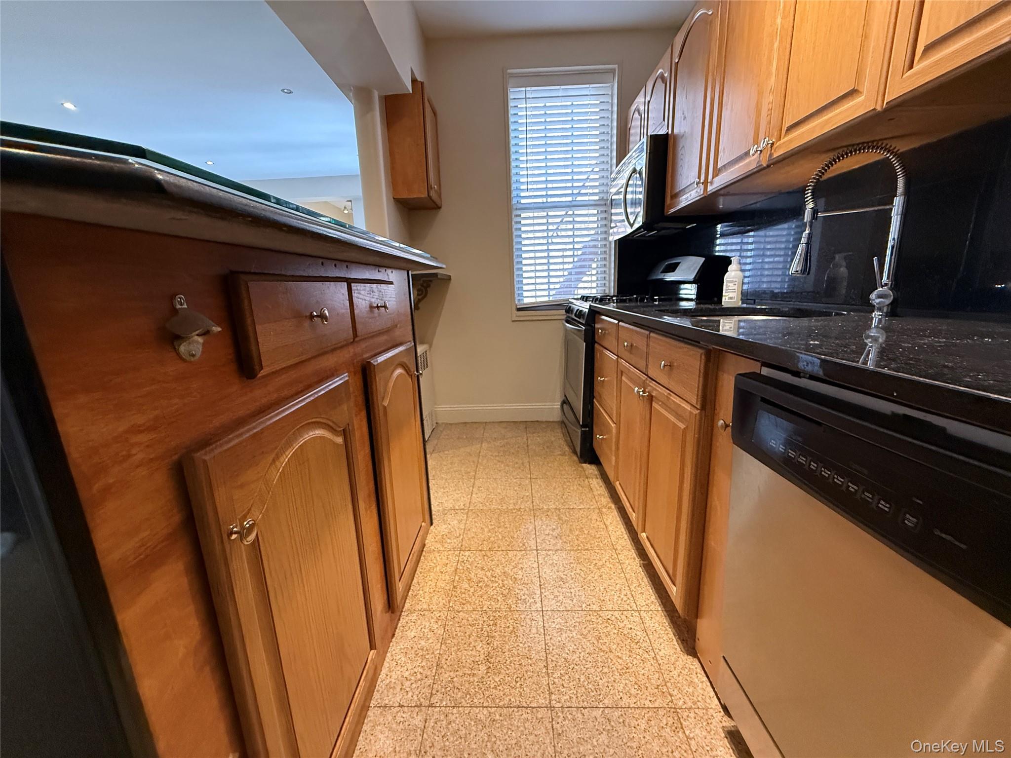 796 Bronx River Road, Unit B38 Bronxville, NY 10708 - Photo 10 of 31 a kitchen with stainless steel appliances granite countertop a refrigerator and a stove