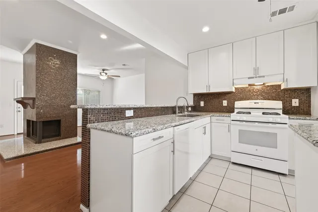 a bathroom with a granite countertop sink a mirror and vanity
