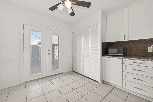 a kitchen with white cabinets and white appliances