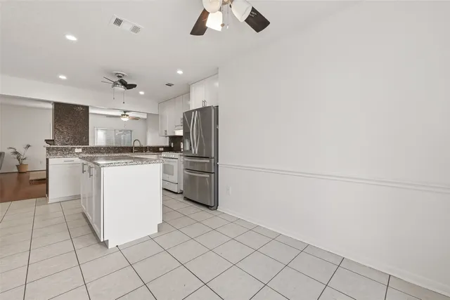 a view of a storage & utility room with cabinets