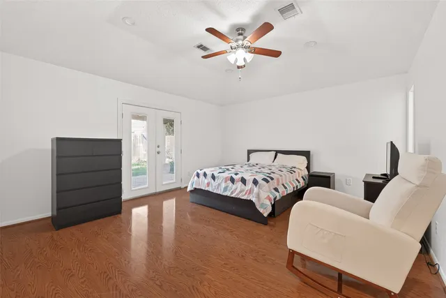 a bedroom with a large bed and a chandelier