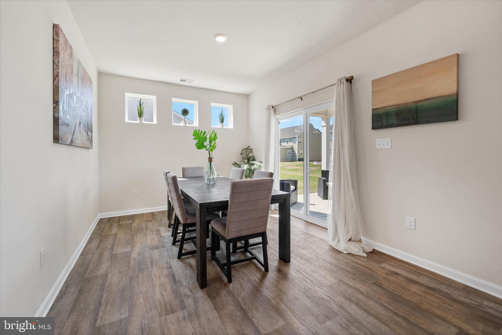 735 Red Maple Road Smyrna, DE 19977 - Photo 11 of 42 a view of a dining room with furniture and wooden floor