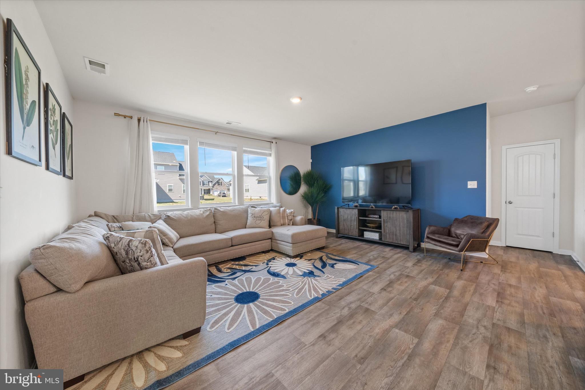 735 Red Maple Road Smyrna, DE 19977 - Photo 12 of 42 a living room with furniture and a flat screen tv