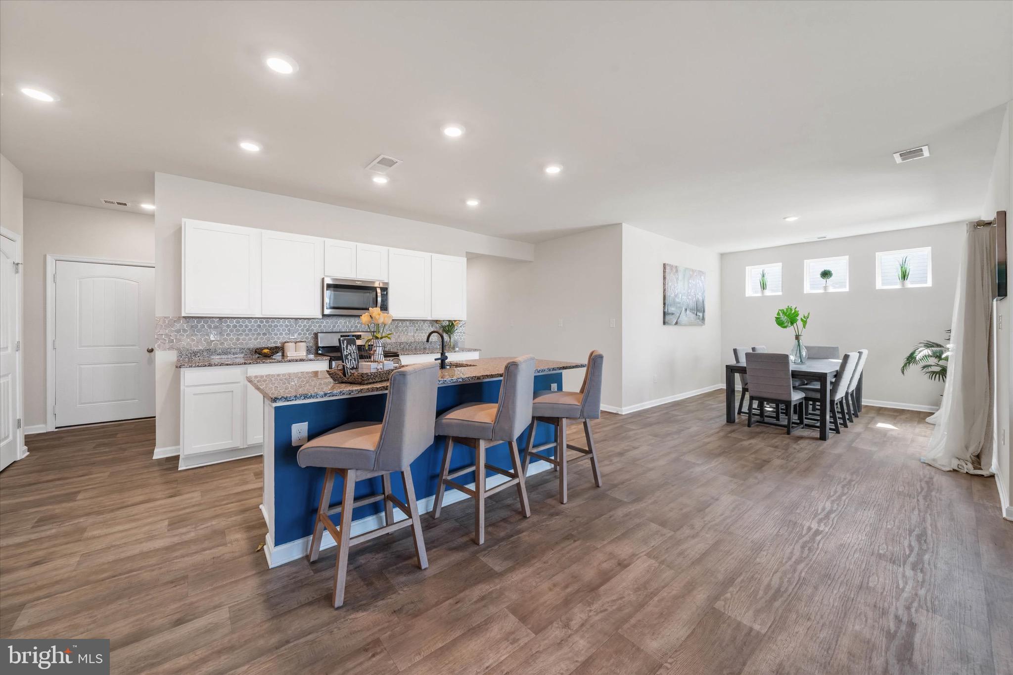 735 Red Maple Road Smyrna, DE 19977 - Photo 13 of 42 a view of a dining room with furniture and wooden floor
