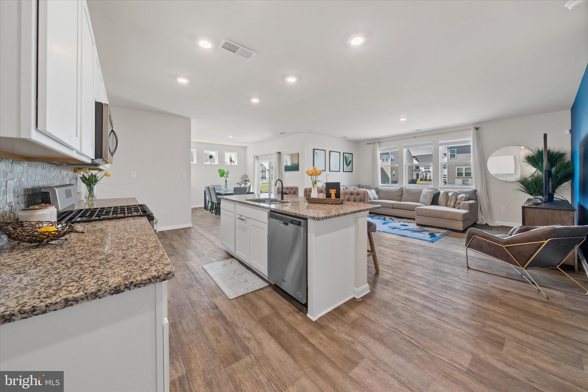 735 Red Maple Road Smyrna, DE 19977 - Photo 14 of 42 a living room with stainless steel appliances granite countertop furniture wooden floor and a view of kitchen