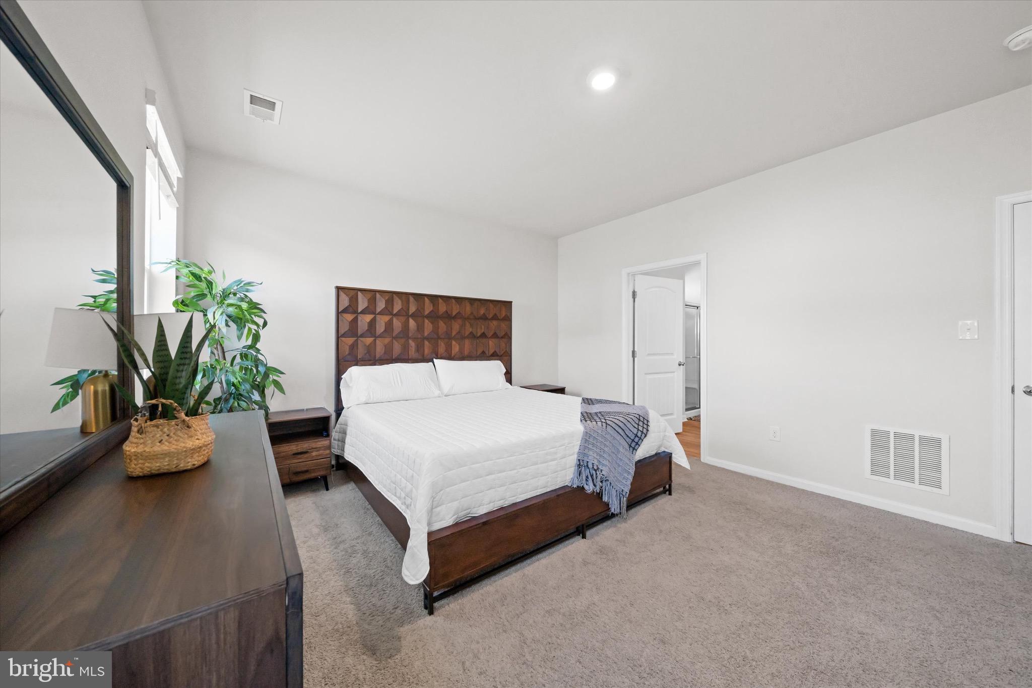 735 Red Maple Road Smyrna, DE 19977 - Photo 22 of 42 a bedroom with a bed and a table