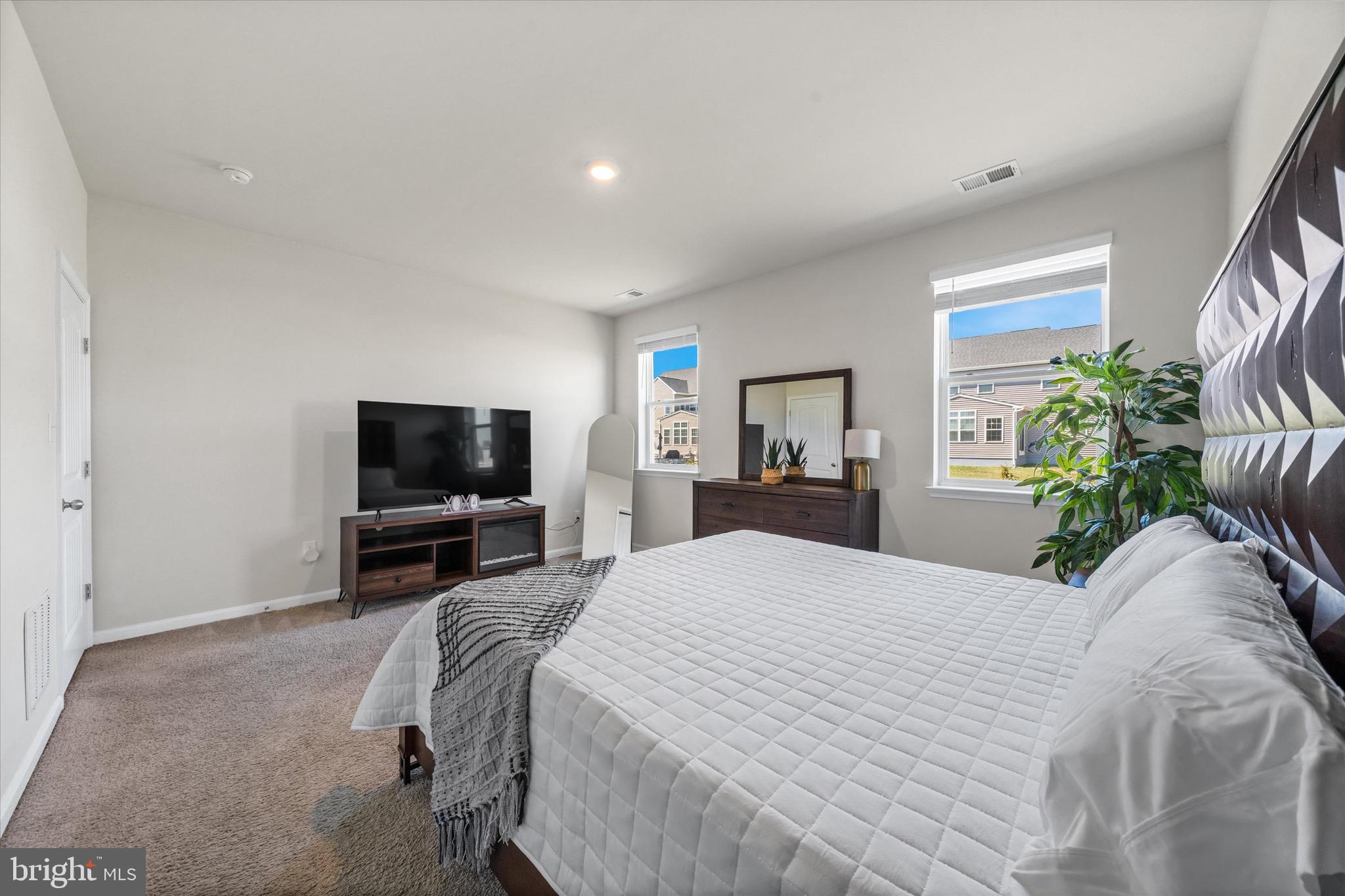 735 Red Maple Road Smyrna, DE 19977 - Photo 23 of 42 a bedroom with a bed and a television