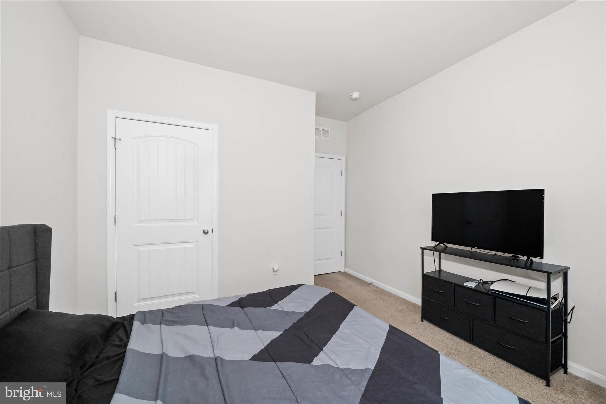 735 Red Maple Road Smyrna, DE 19977 - Photo 27 of 42 a living room with furniture and a flat screen tv