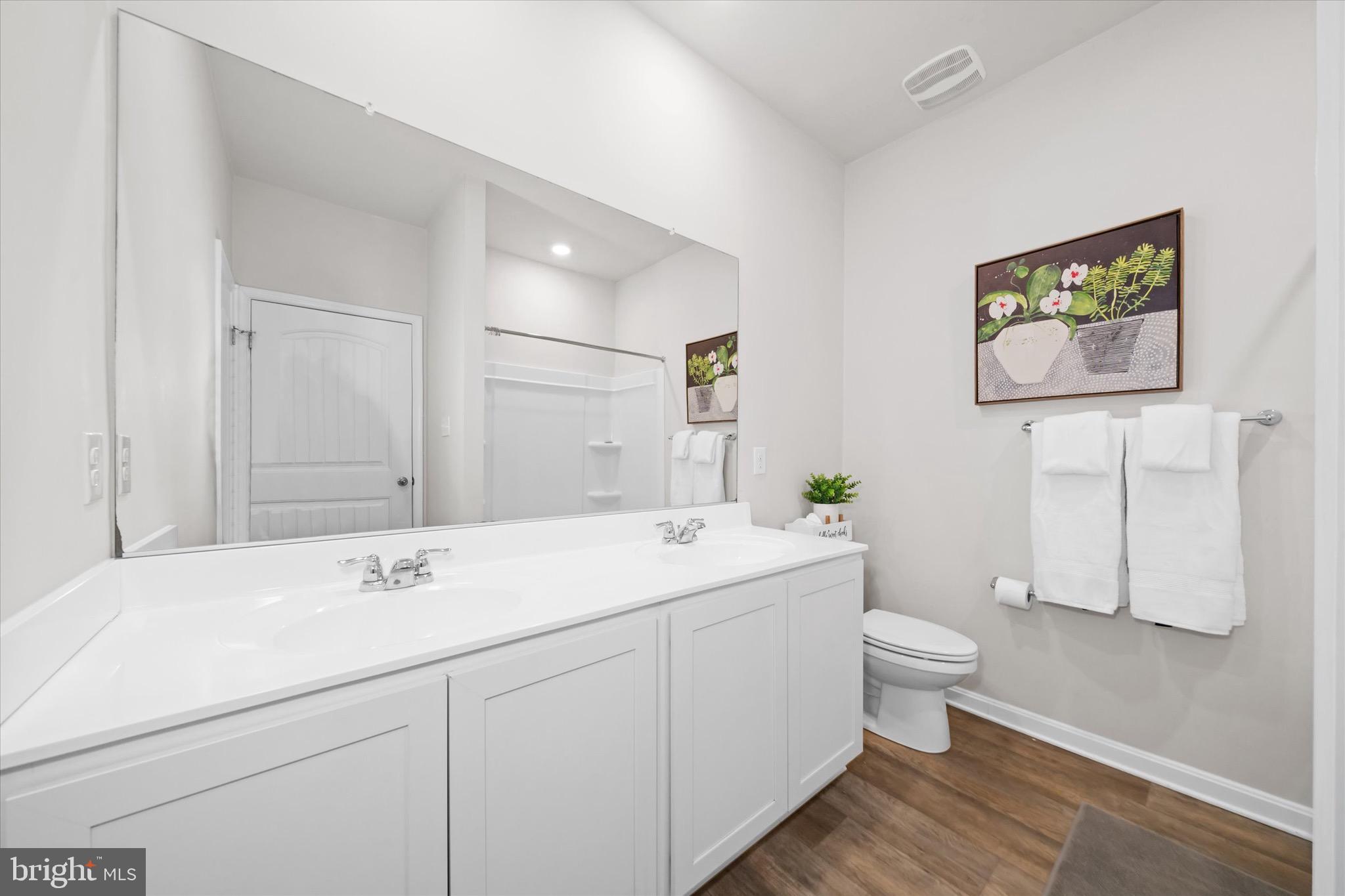 735 Red Maple Road Smyrna, DE 19977 - Photo 28 of 42 a spacious bathroom with a toilet sink and mirror