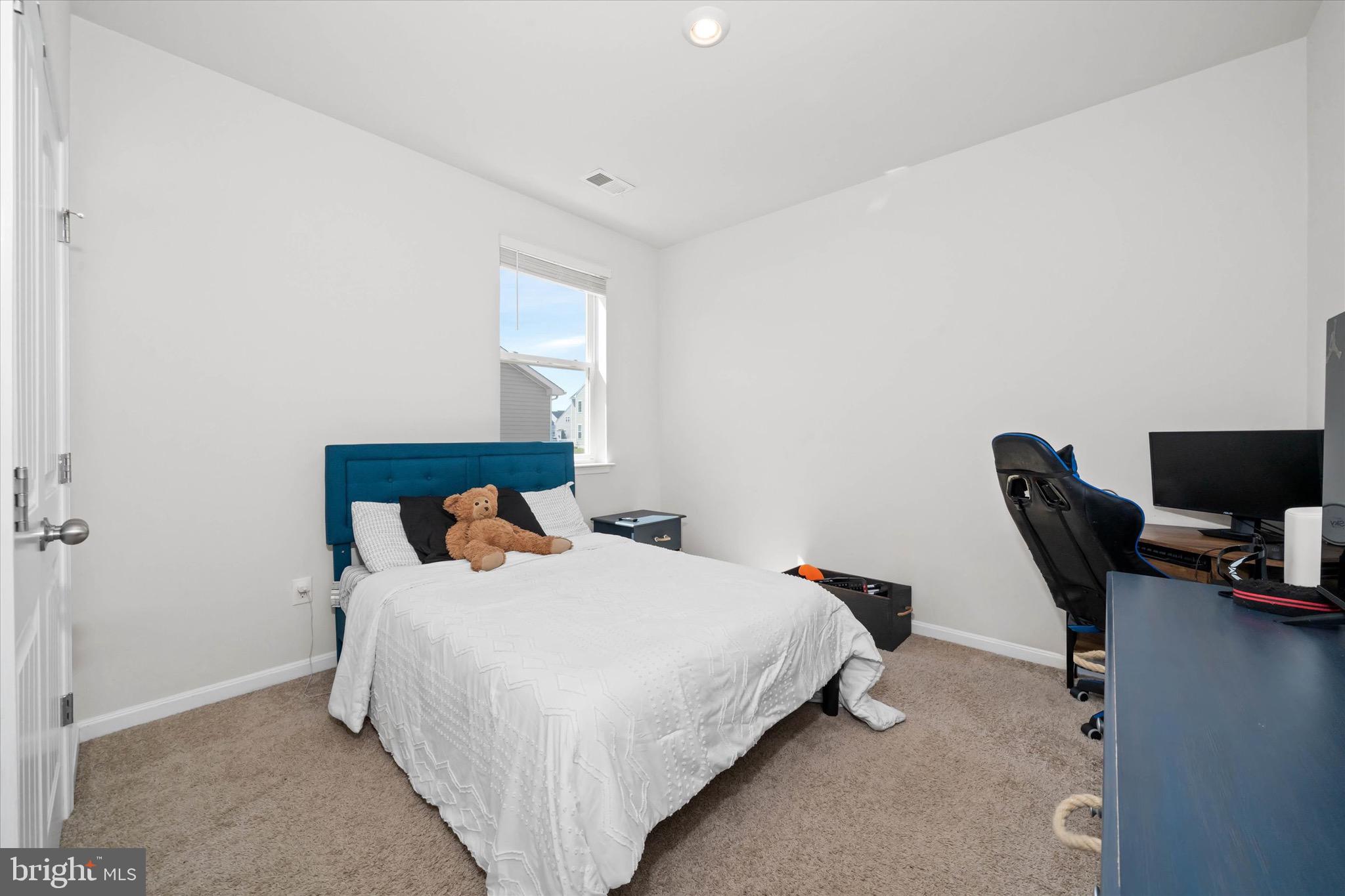 735 Red Maple Road Smyrna, DE 19977 - Photo 30 of 42 a bedroom with a bed and a desk