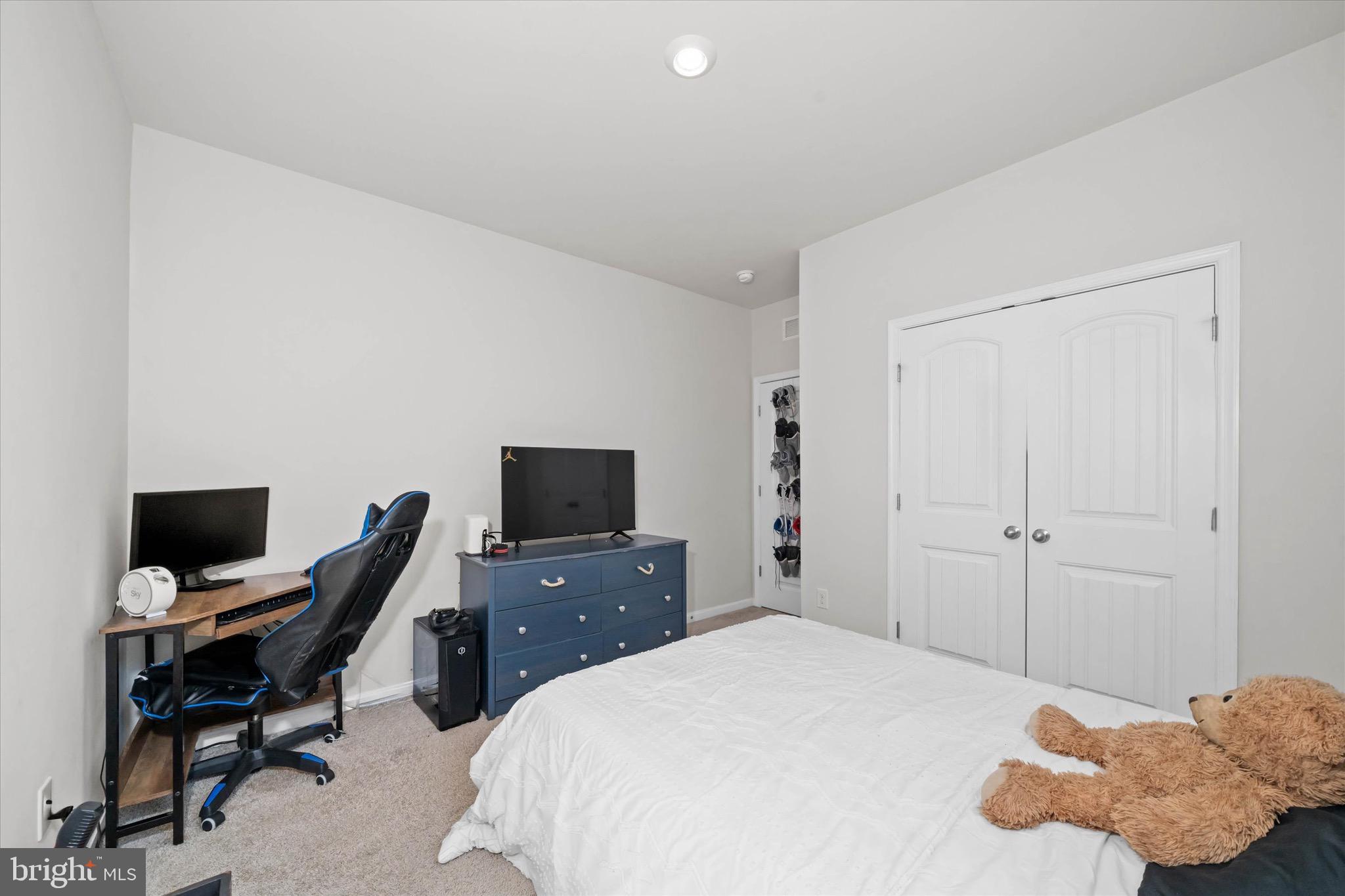 735 Red Maple Road Smyrna, DE 19977 - Photo 31 of 42 a bedroom with a bed and a flat screen tv