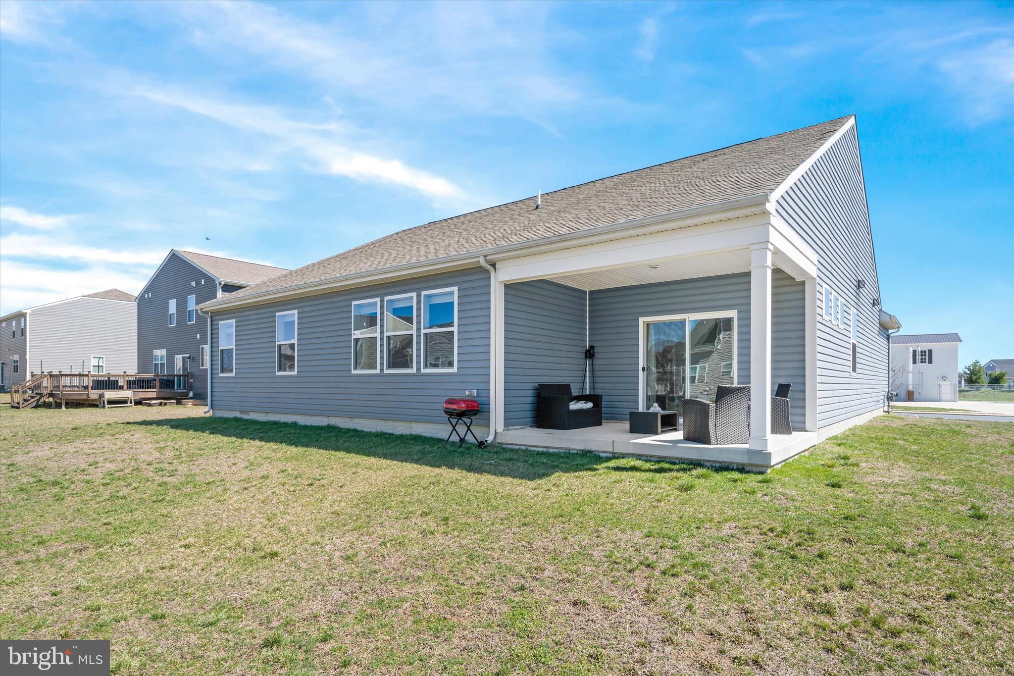 735 Red Maple Road Smyrna, DE 19977 - Photo 34 of 42 a view of a house with a yard and sitting area