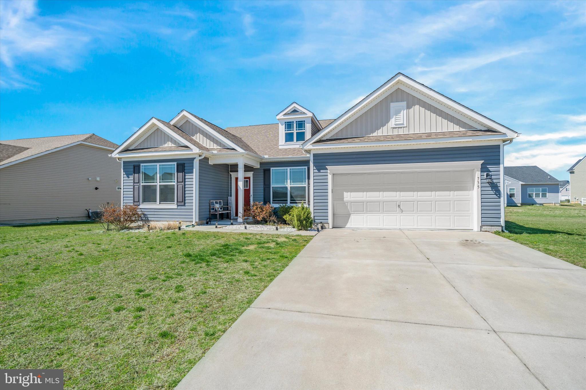 735 Red Maple Road Smyrna, DE 19977 - Photo 4 of 42 a front view of a house with a yard