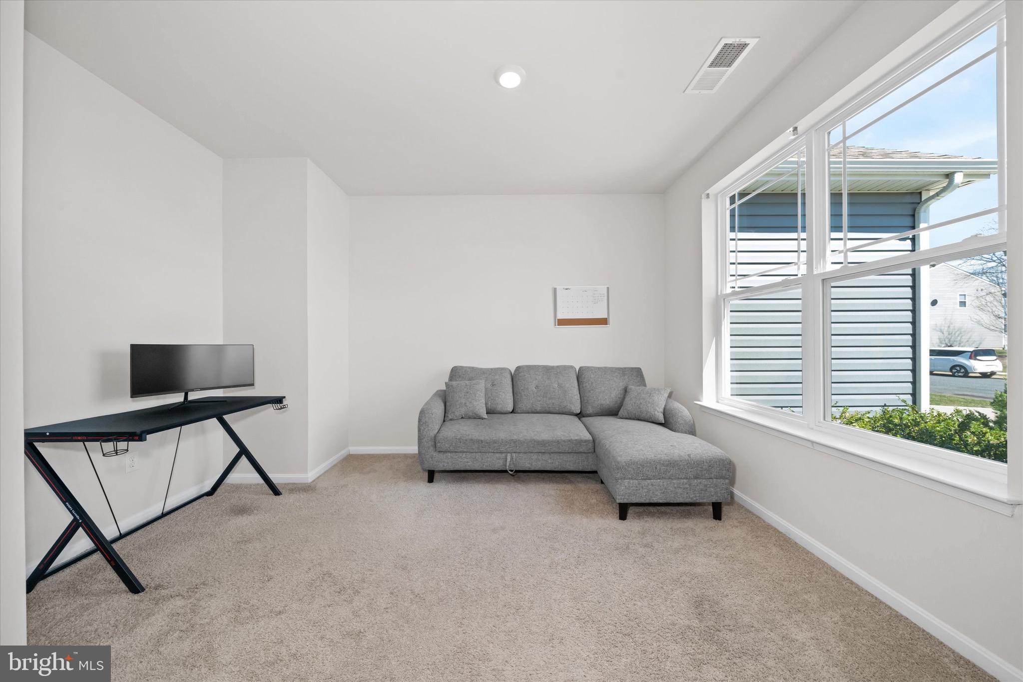 735 Red Maple Road Smyrna, DE 19977 - Photo 8 of 42 a living room with furniture and a window