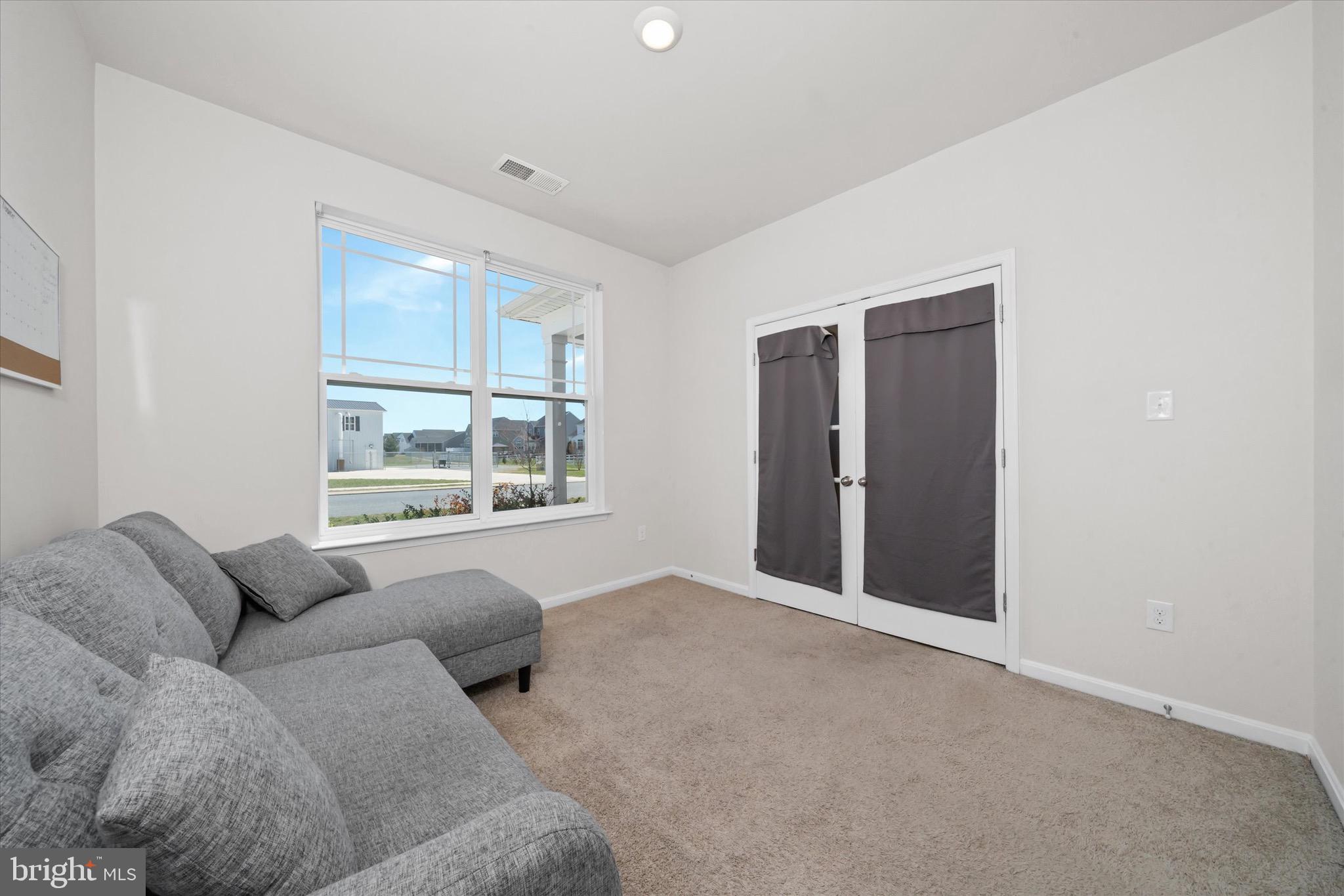 735 Red Maple Road Smyrna, DE 19977 - Photo 9 of 42 a living room with furniture and windows