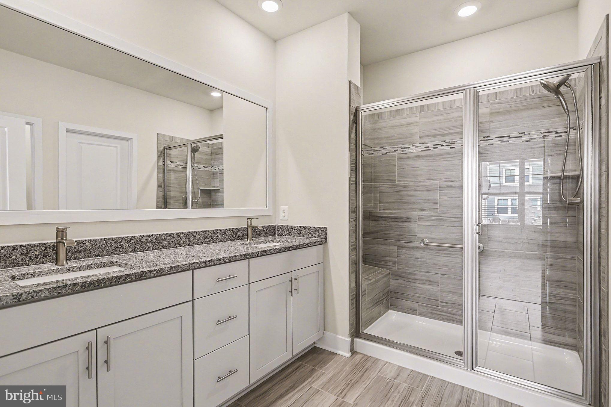 63 Rustic Wood Drive Gettysburg, PA 17325 - Photo 18 of 49 a bathroom with a granite countertop sink a mirror a glass door and shower