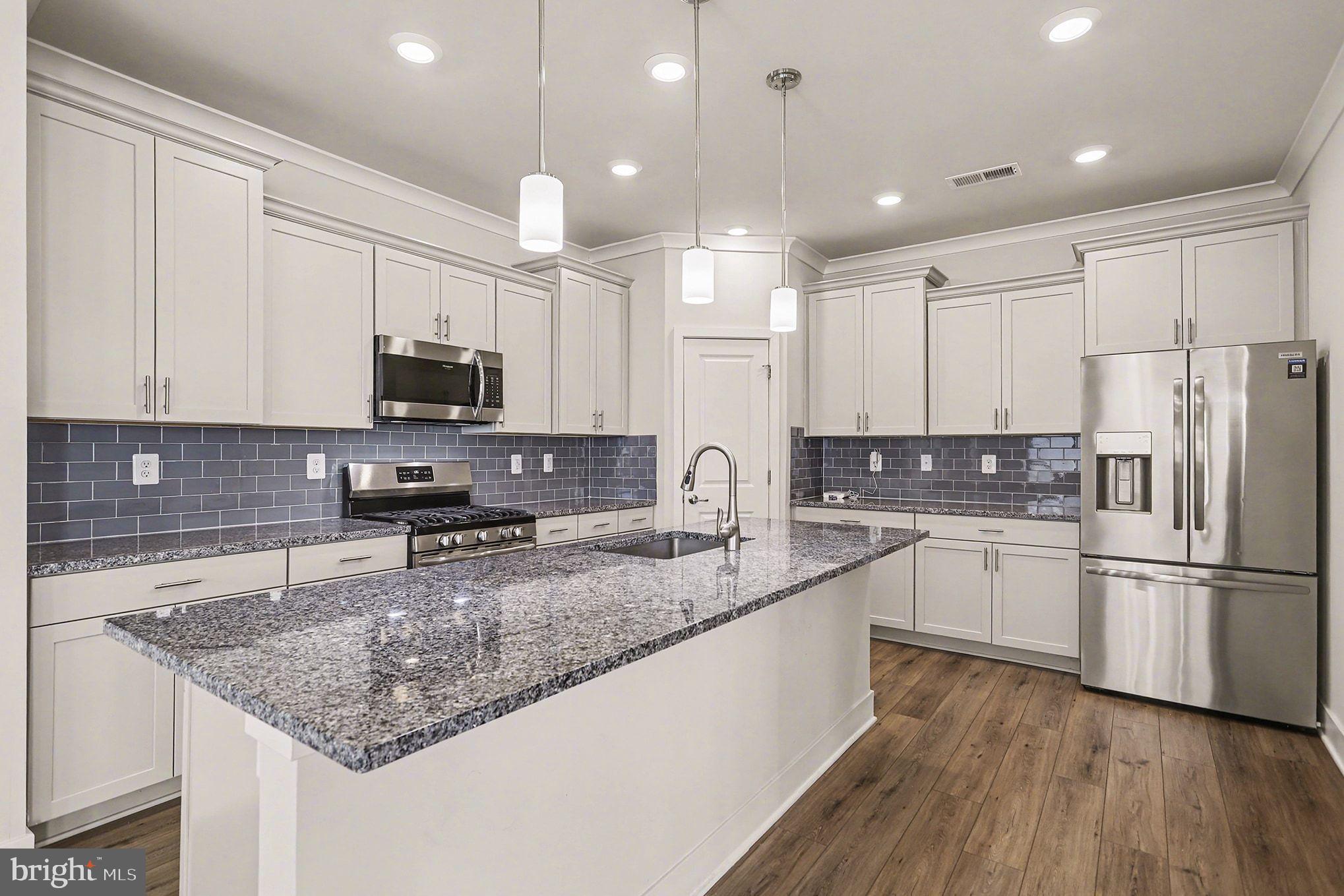 63 Rustic Wood Drive Gettysburg, PA 17325 - Photo 10 of 49 a kitchen with stainless steel appliances granite countertop a sink refrigerator and microwave