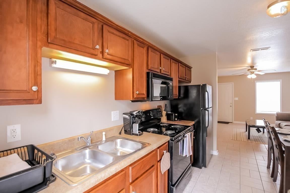 535 Lafayette Road, Unit I1 Clarksville, TN 37042 - Photo 3 of 24 a kitchen with stainless steel appliances a sink a stove cabinets and a dining table