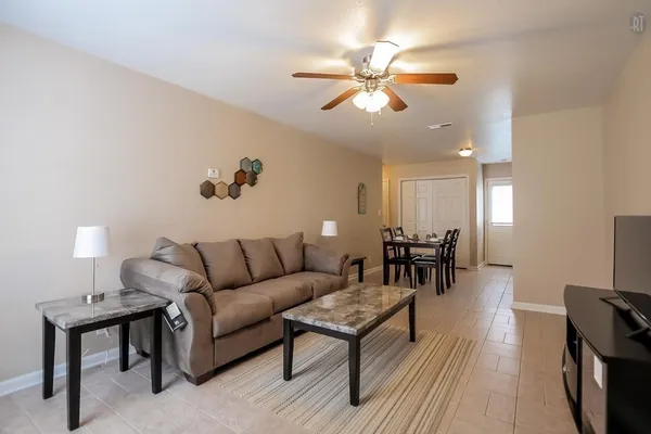 a living room with furniture and a chandelier