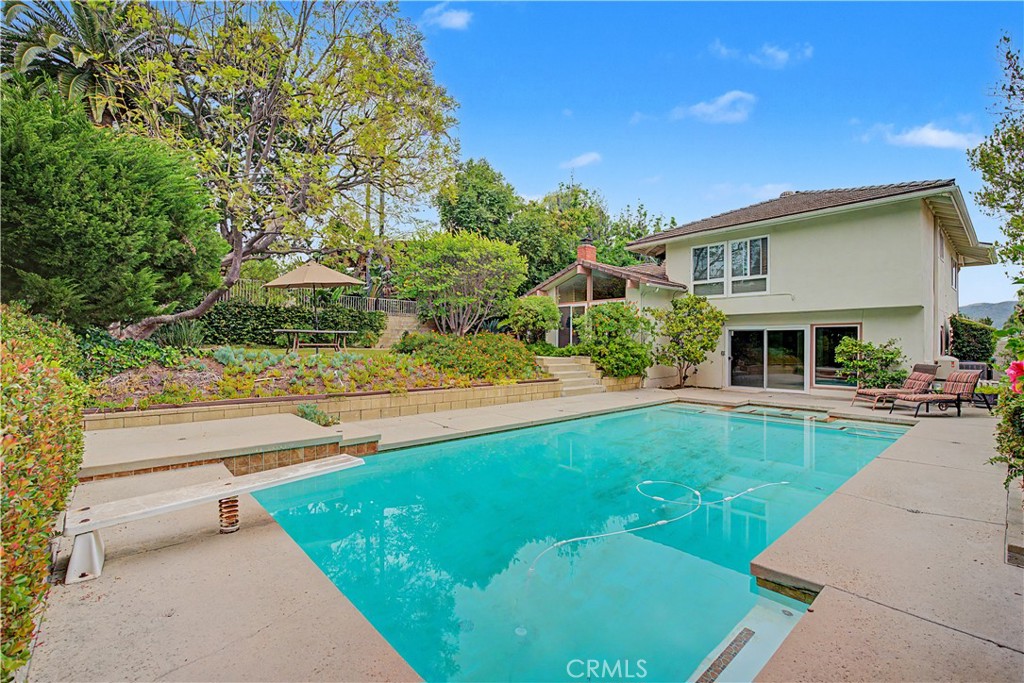 22671 Town Crier Road Calabasas, CA 91302 - Photo 11 of 35 a front view of a house with swimming pool having outdoor seating