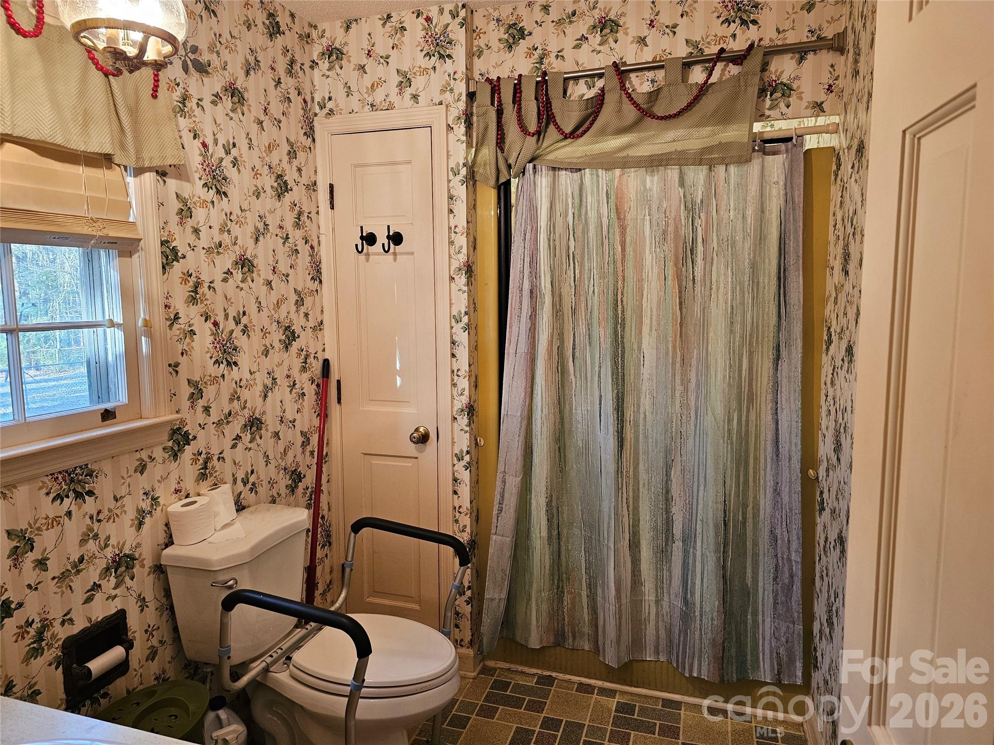 979 Suttle Road Lancaster, SC 29720 - Photo 13 of 26 a bathroom with a sink a toilet and shower curtain