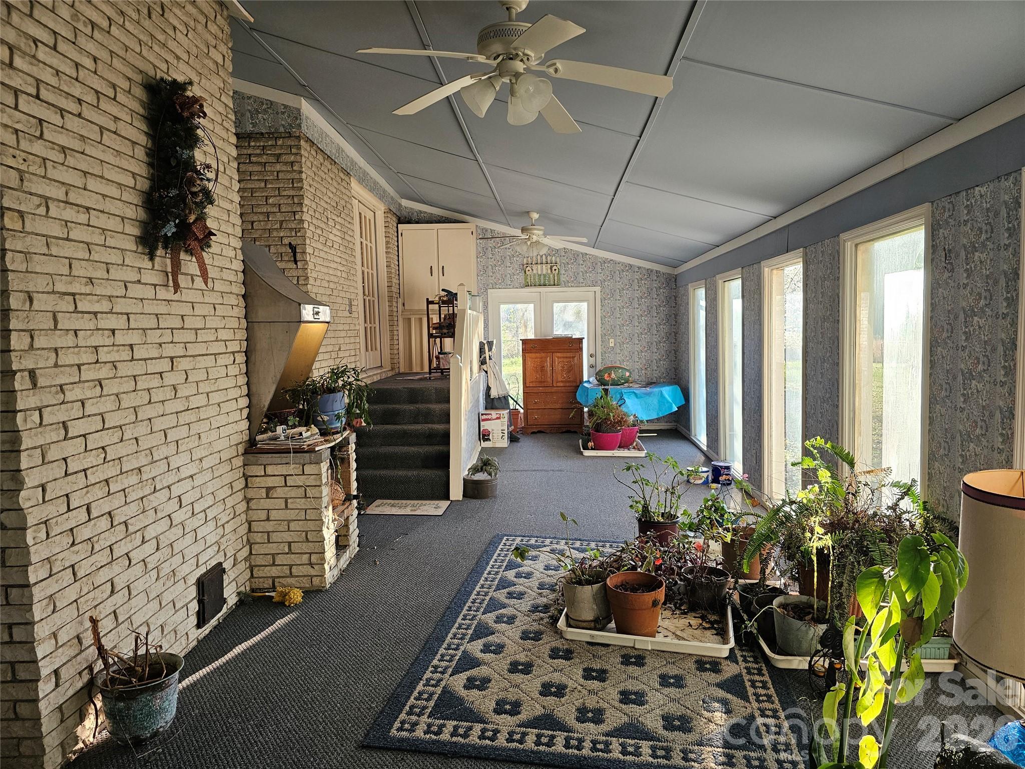 979 Suttle Road Lancaster, SC 29720 - Photo 14 of 26 a hallway with a potted plant on the table and a stove